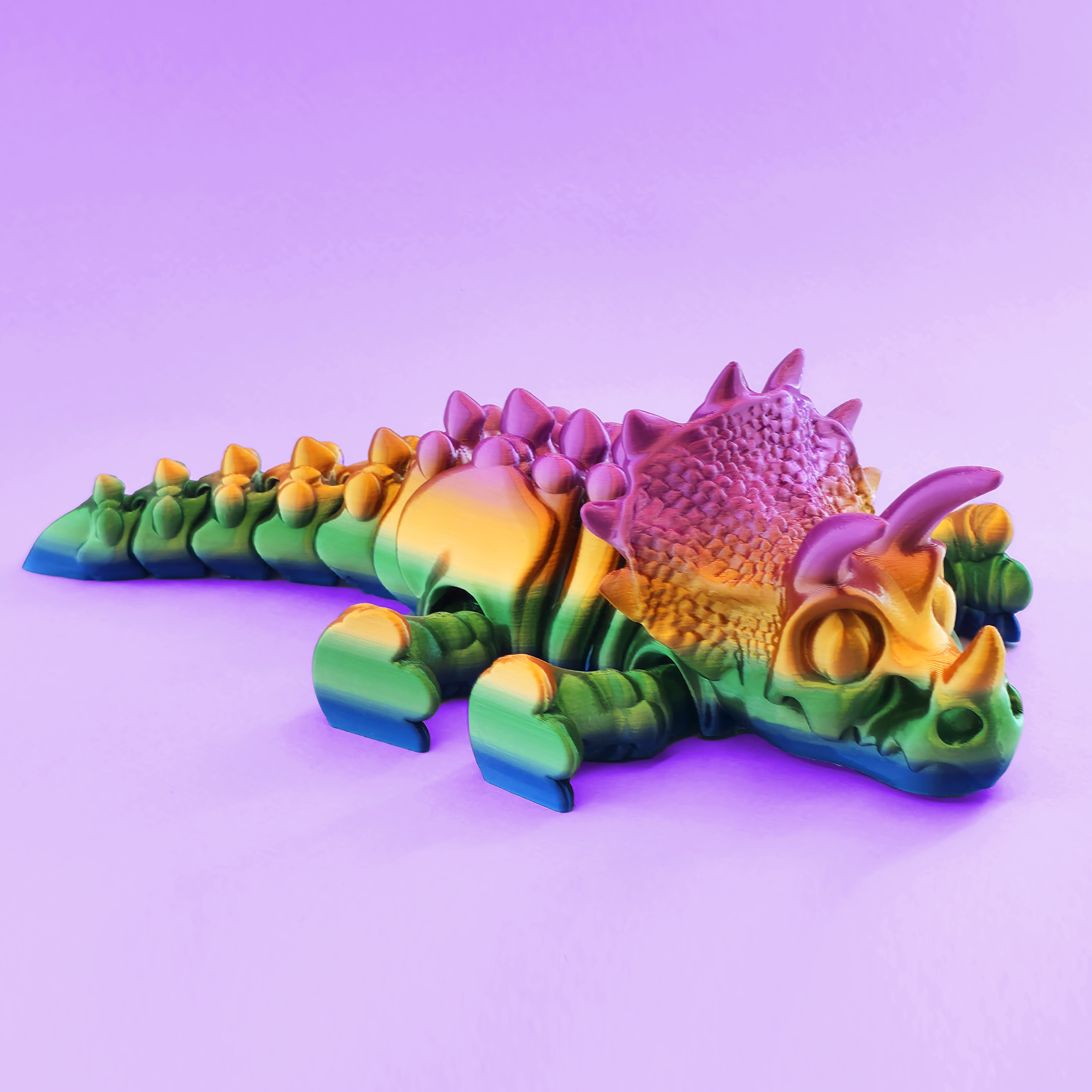 Colorful dinosaur toy on a purple background