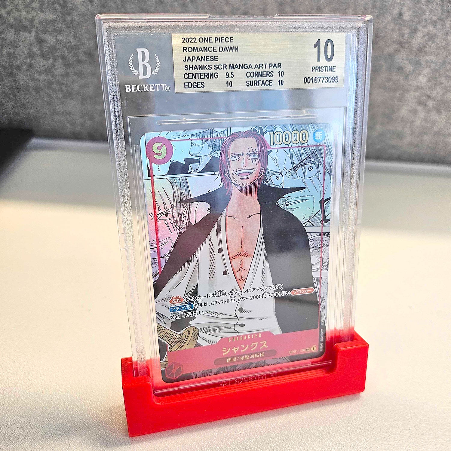 Collection of graded trading cards in PSA, BGS, and CGC slabs on a display stand