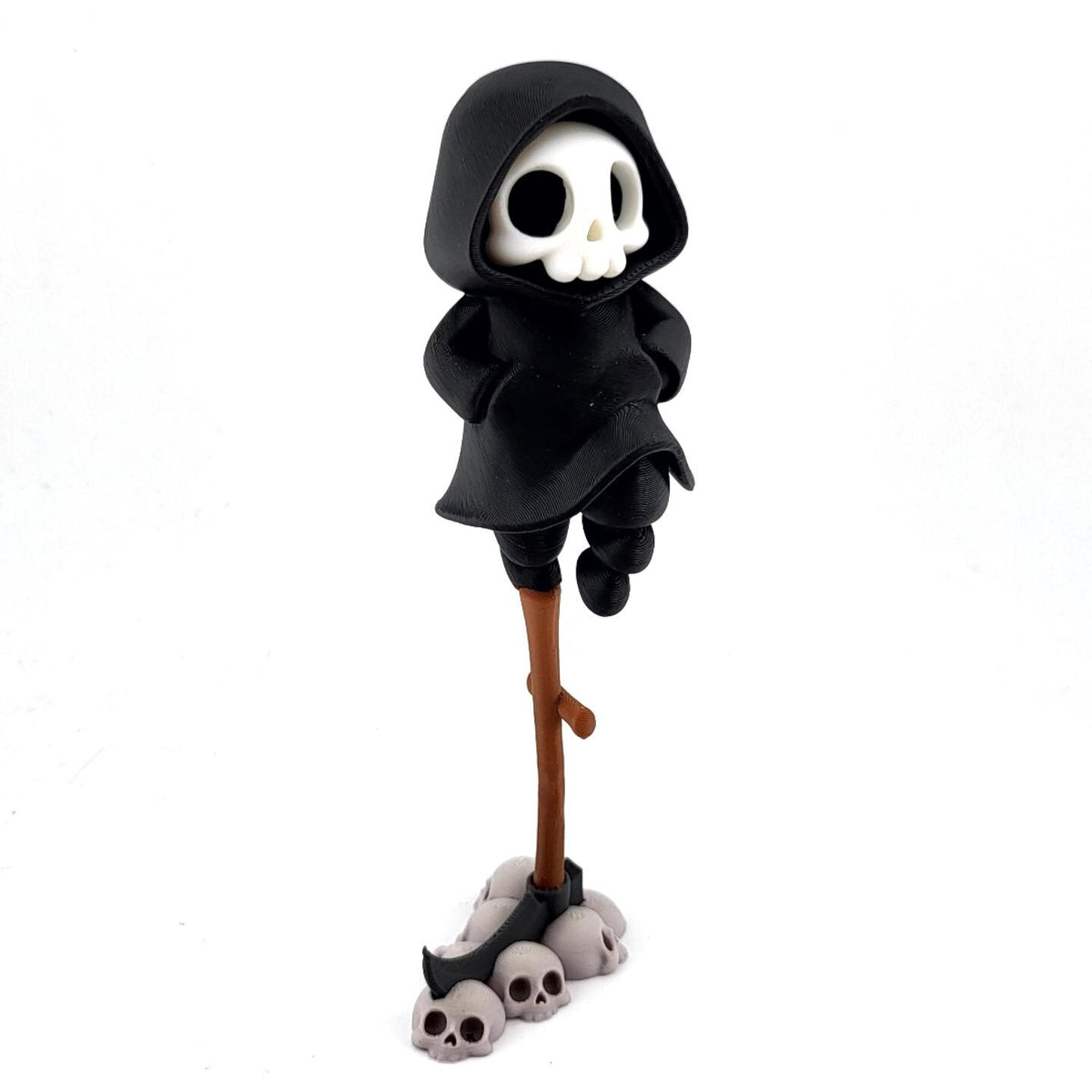 The Lookout grim reaper perched on top of a tall scythe handle above a pile of skulls