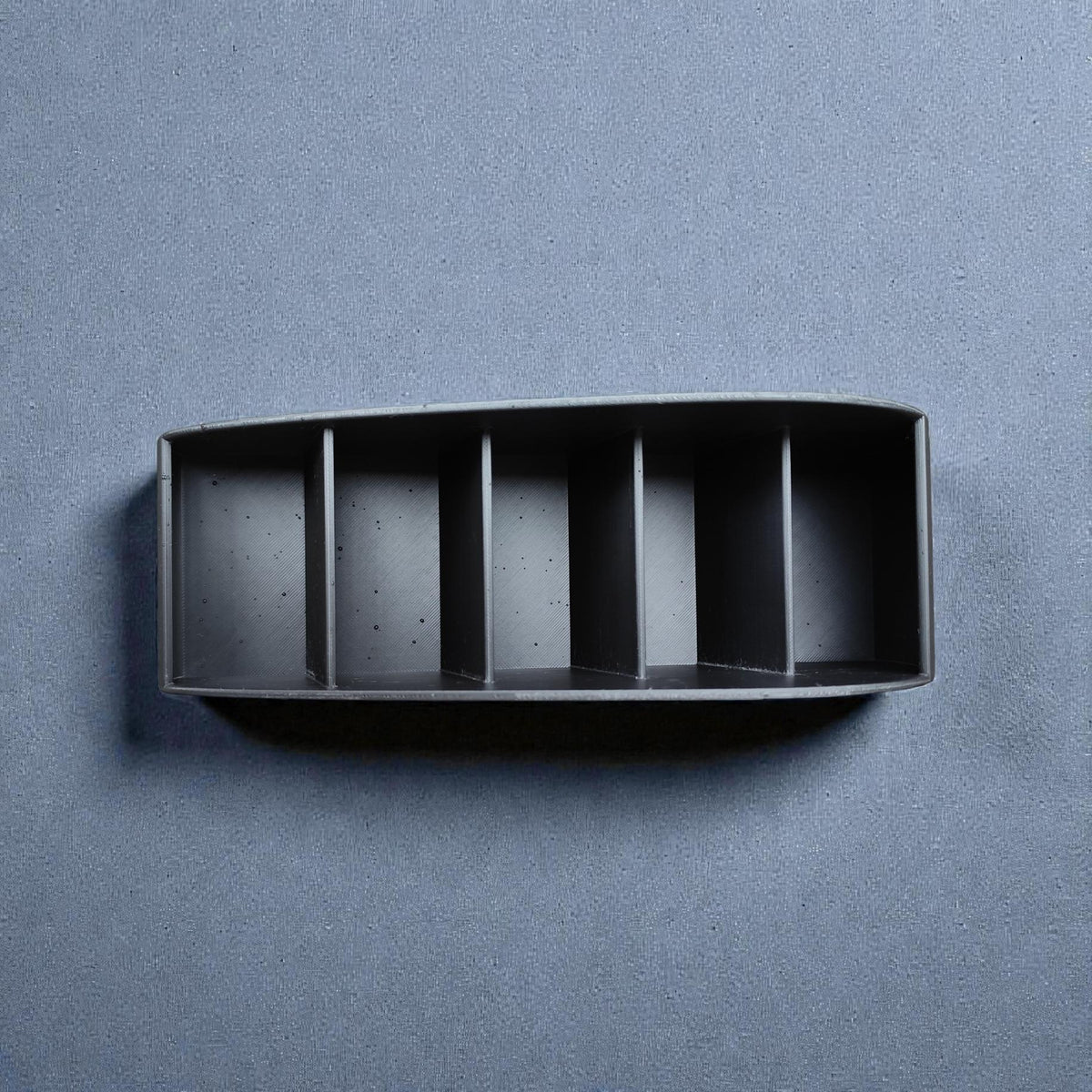 Remote caddy from above, showing the slots