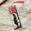Bookmark with samurai design and pink cherry blossoms on a textured surface