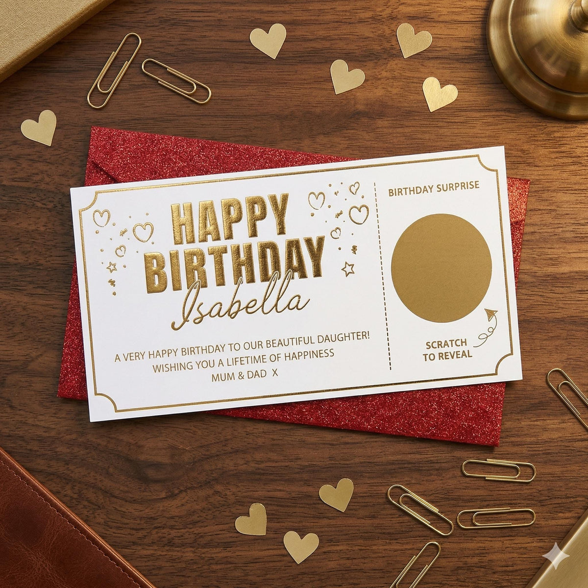 Gold foil birthday scratch card on a red glitter envelope with paper hearts