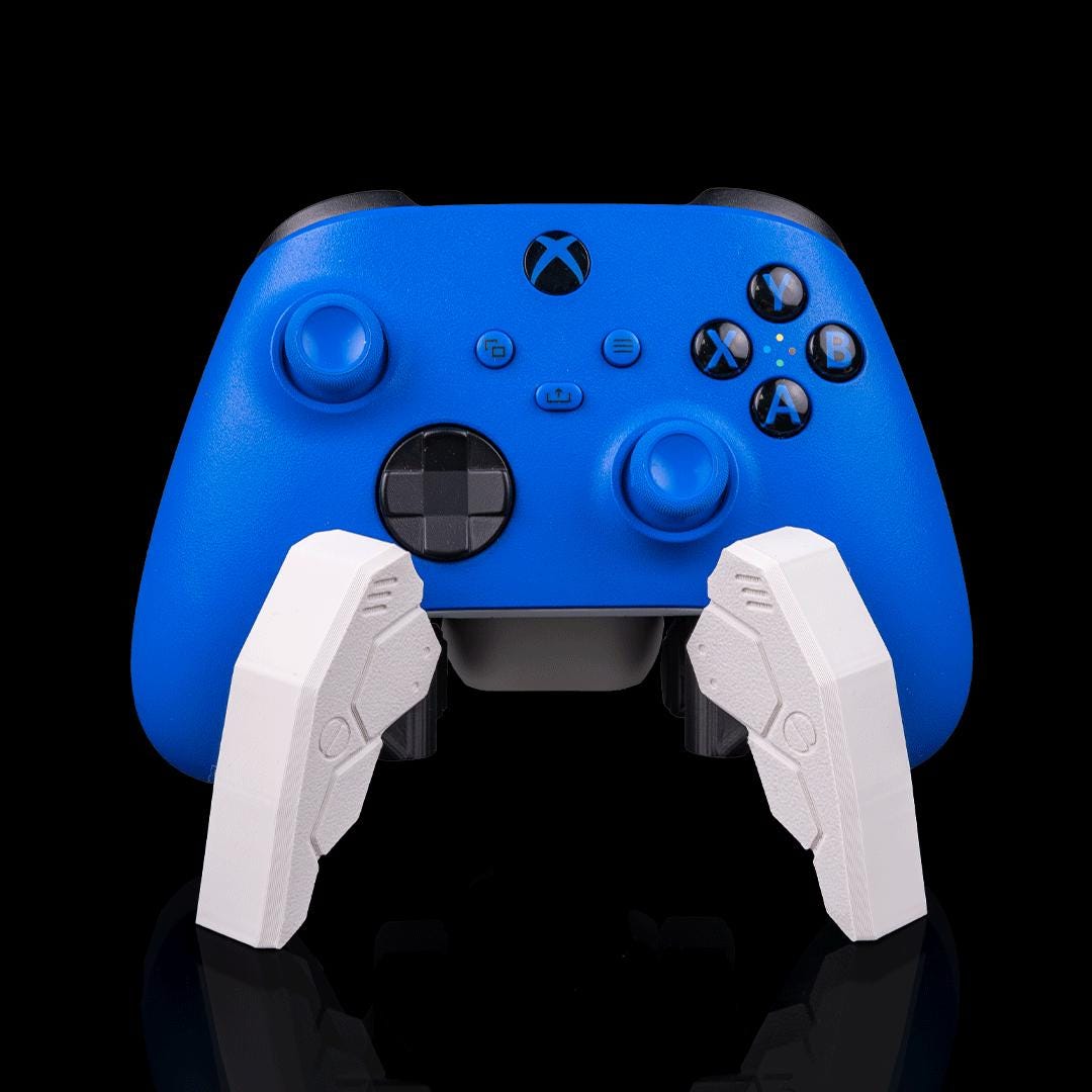 White robot spider controller stand holding a blue Xbox controller