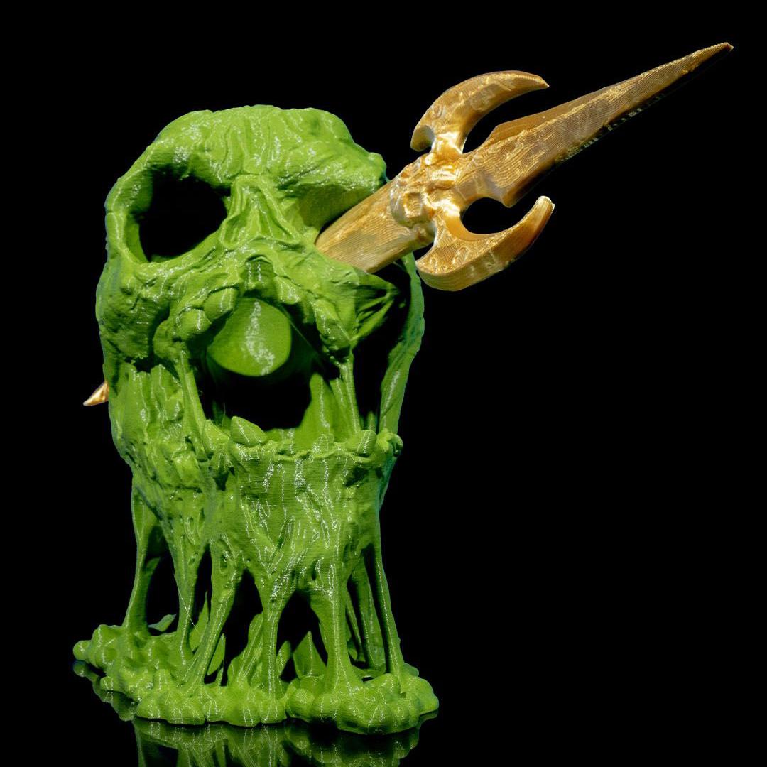 Green creature figurine with a gold horn on a black background