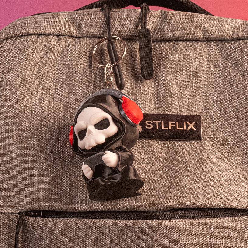 Small Gamer Grim Reaper keyring clipped to a backpack