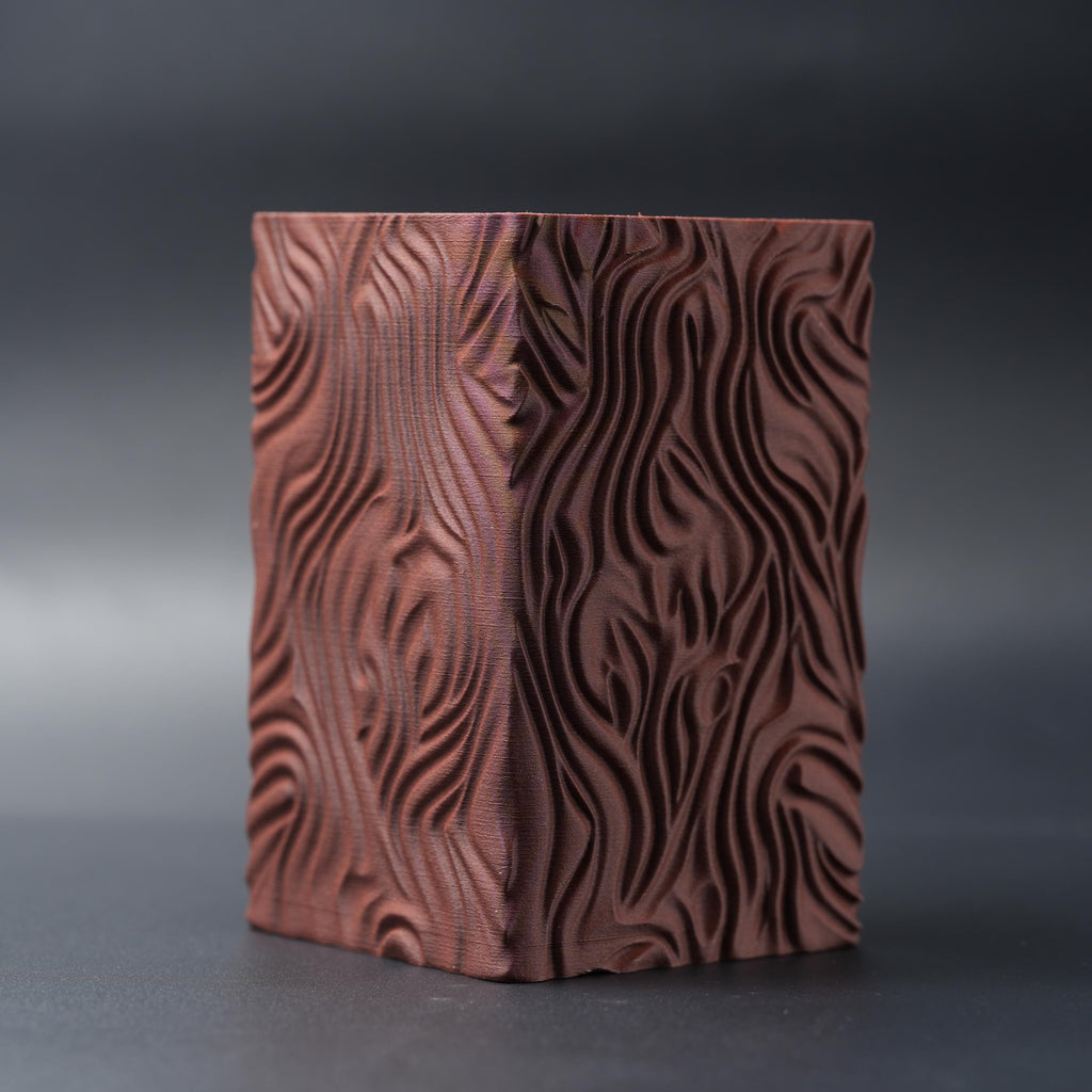 Terracotta pencil holder from the front, showing the flowing pattern