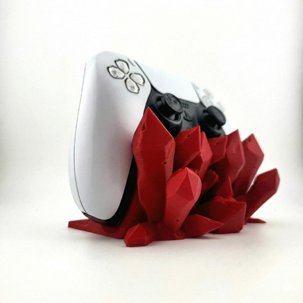 Red crystal controller stand from the side, with a PS5 controller