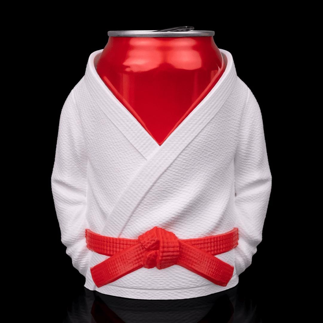 Gi holder from the front with a red belt, holding a red drinks can