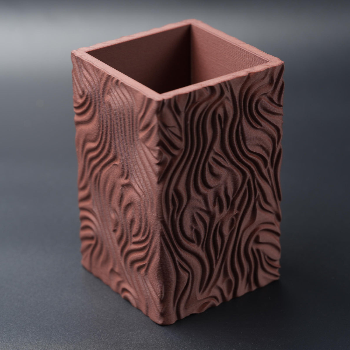 Empty terracotta pencil holder from above at an angle