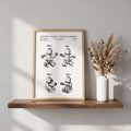 Toy figure patent print, sheet 2, in white with black lines, in a wood frame
