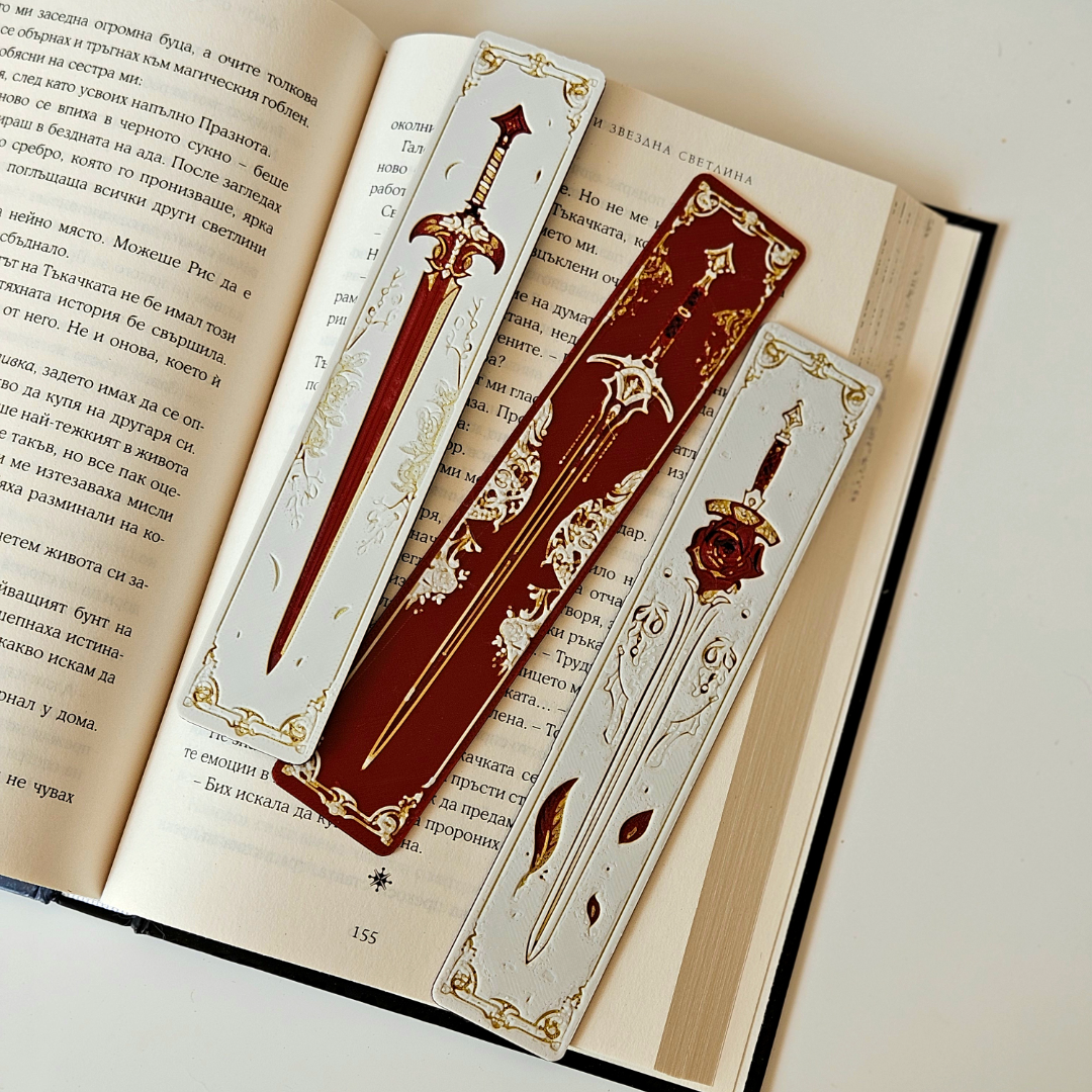 Decorative bookmarks with sword designs on an open book