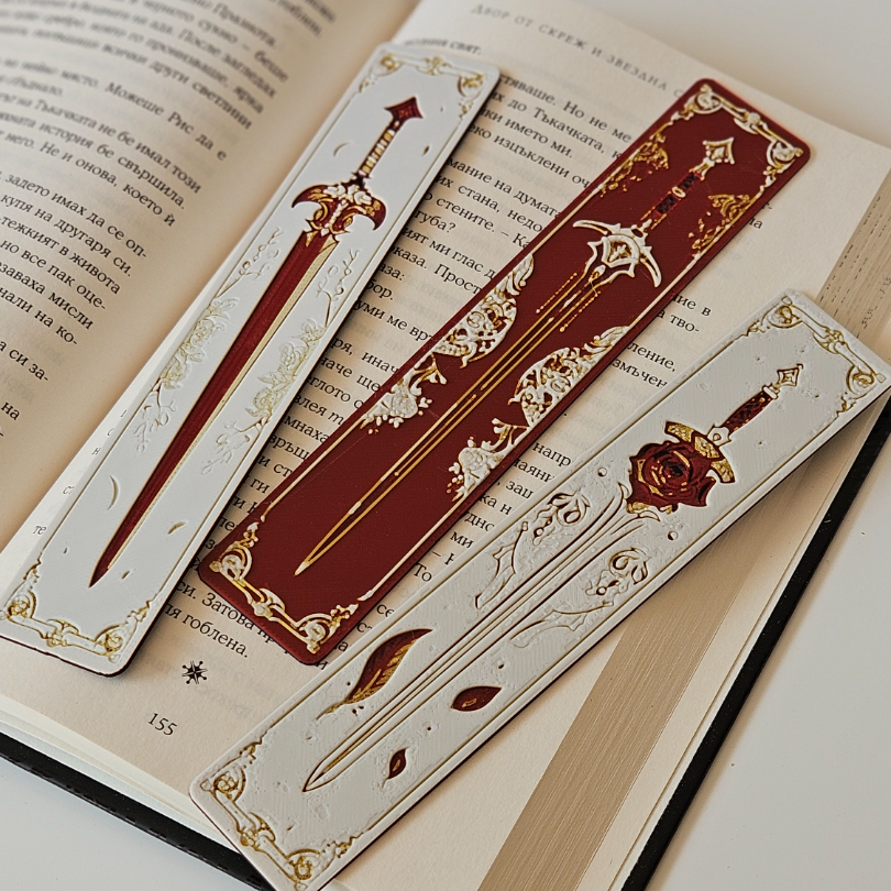 Decorative bookmarks with sword designs on an open book