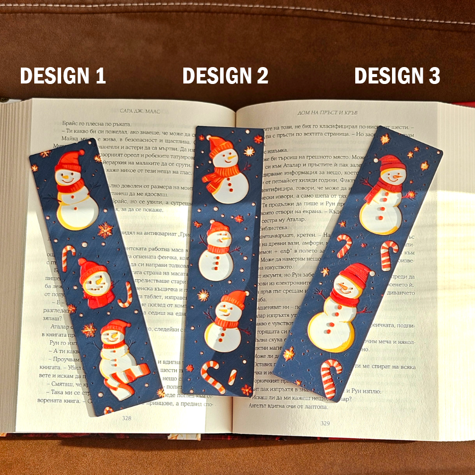 Three Christmas-themed bookmarks on an open book with 'Design 1', 'Design 2', and 'Design 3' labels above.