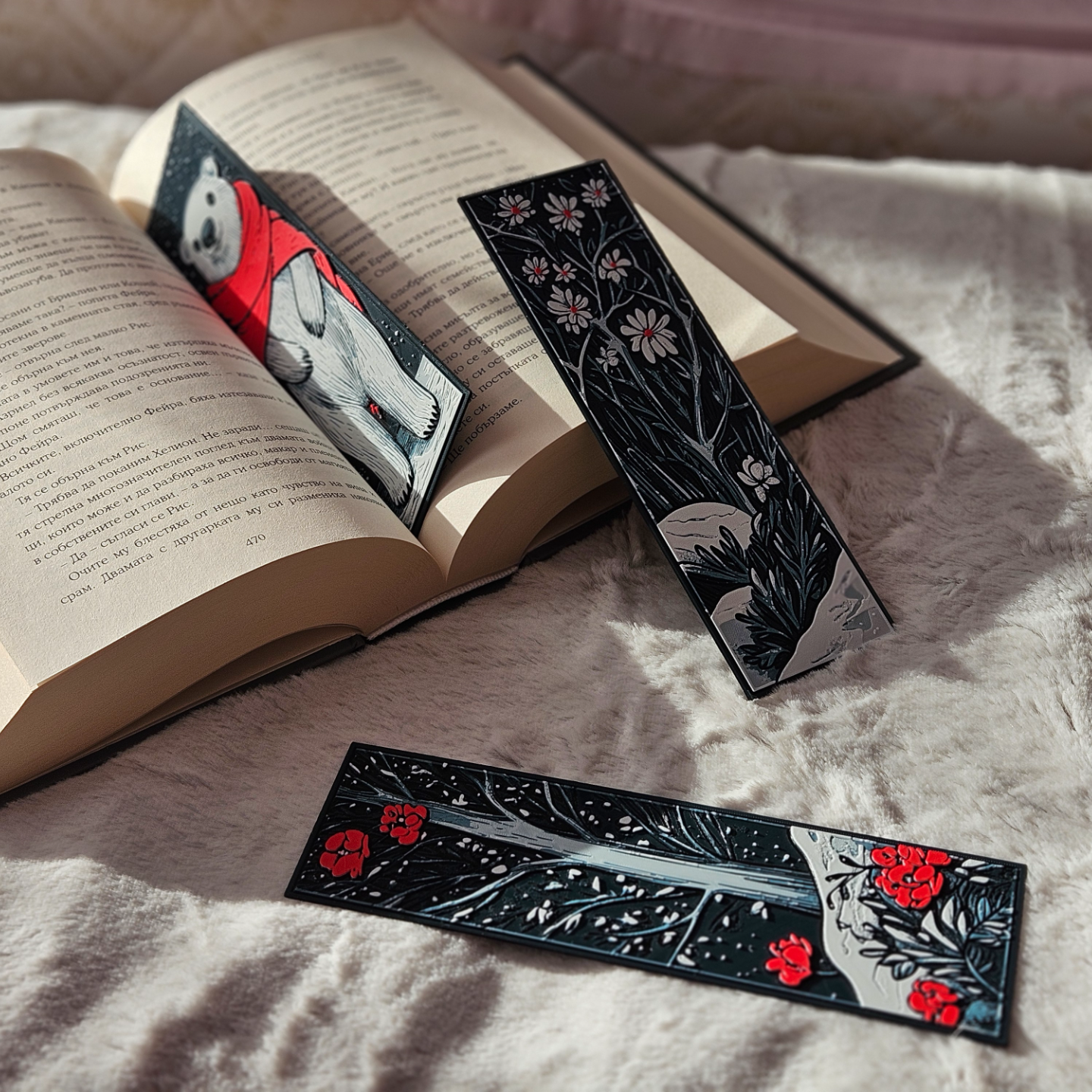 Three decorative bookmarks on an open book with a soft background