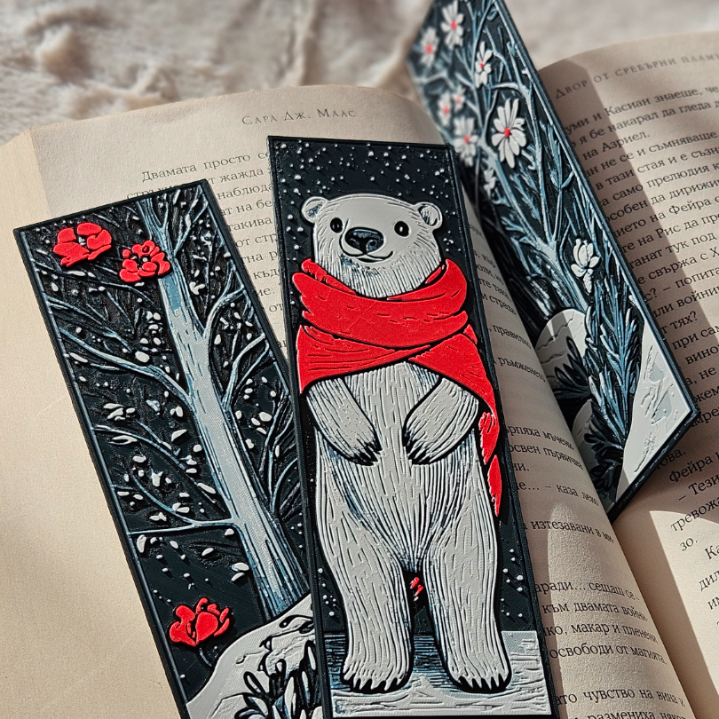 Three decorative bookmarks with different designs on an open book.