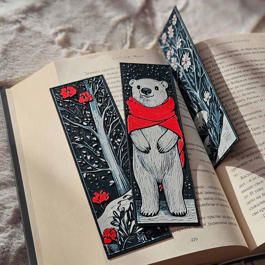Three decorative bookmarks with illustrations on an open book