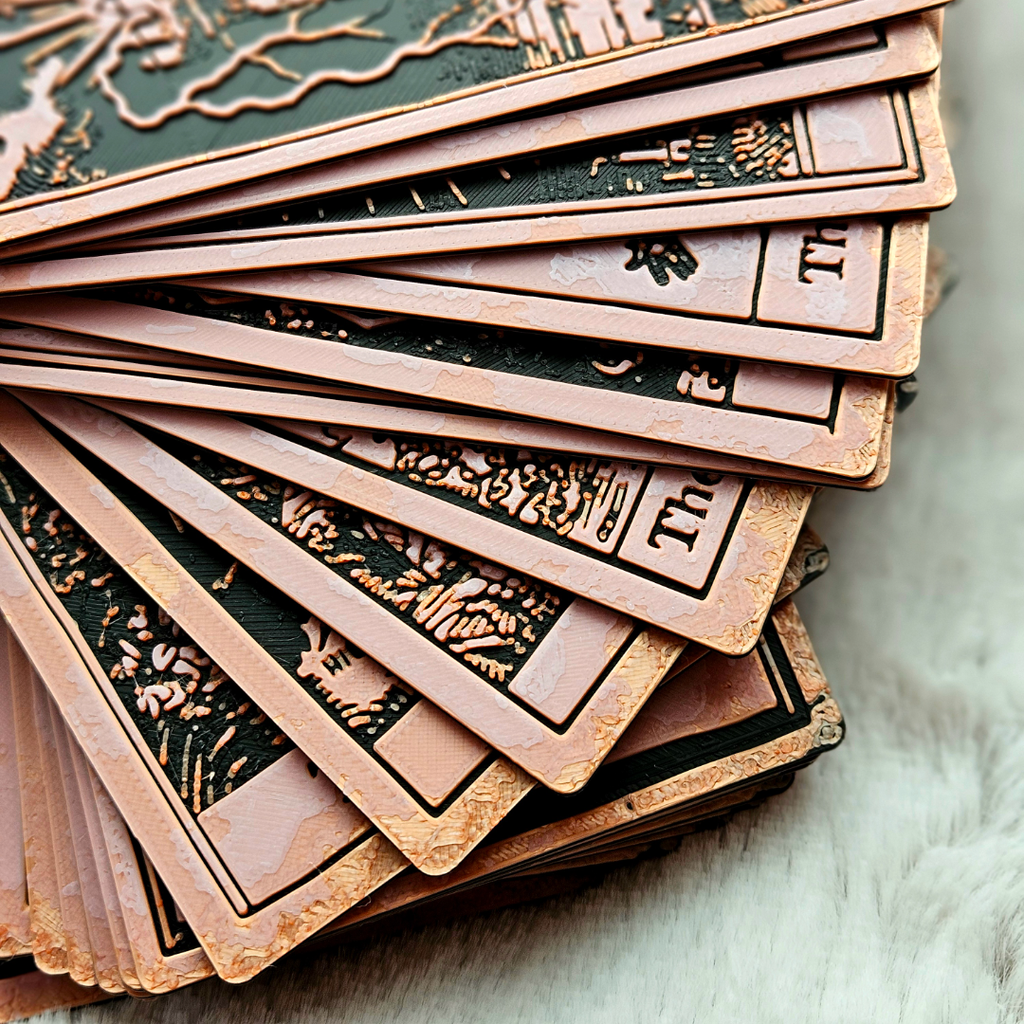 Stack of intricately designed cards on a textured surface