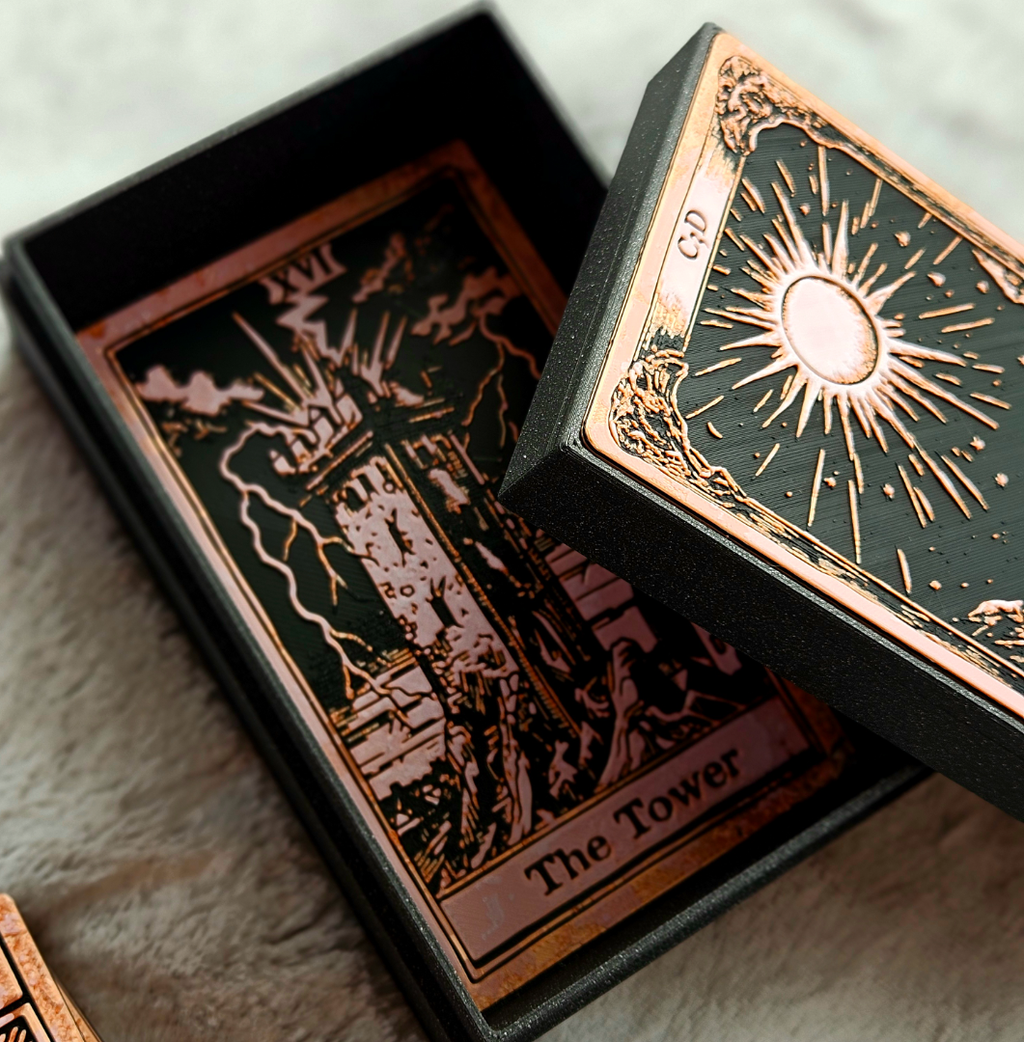 Close-up of a tarot card with 'The Tower' symbol and a decorative box.