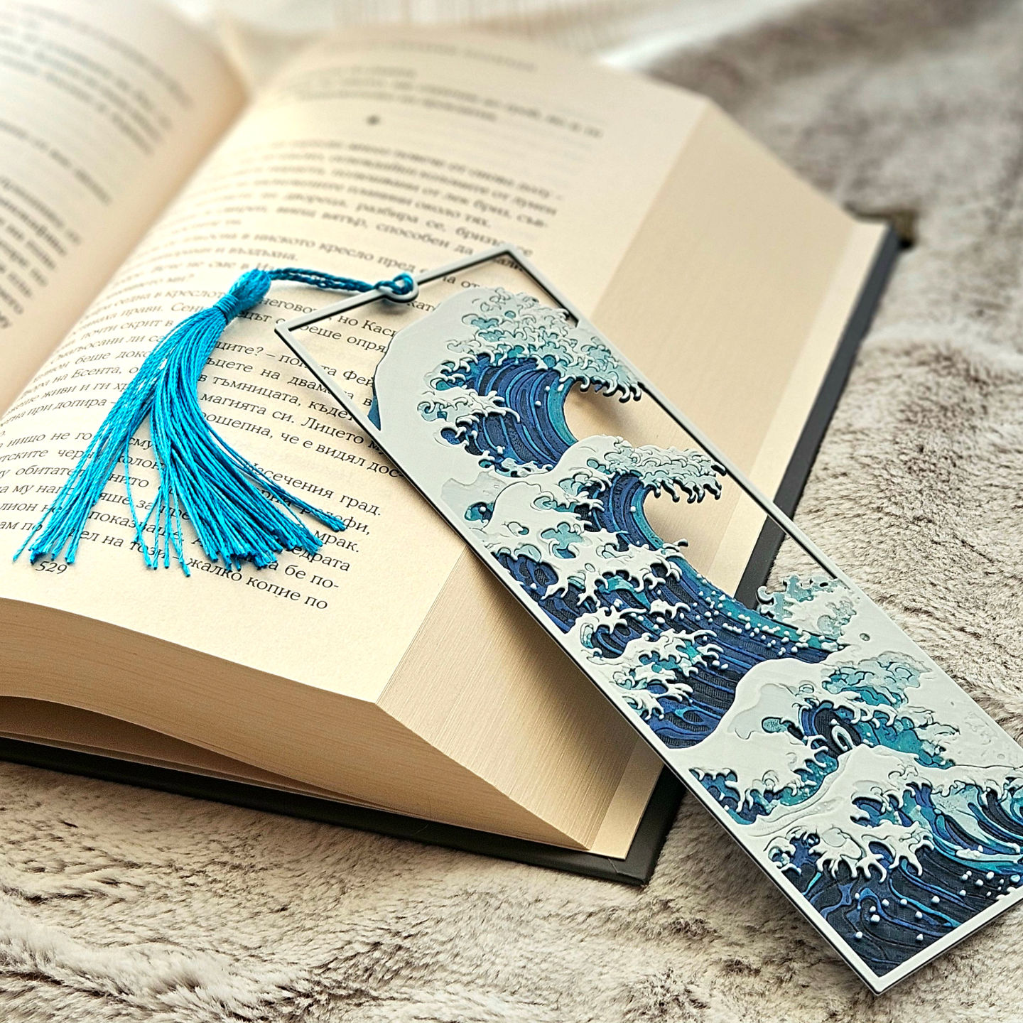 Decorative bookmark with wave design on an open book