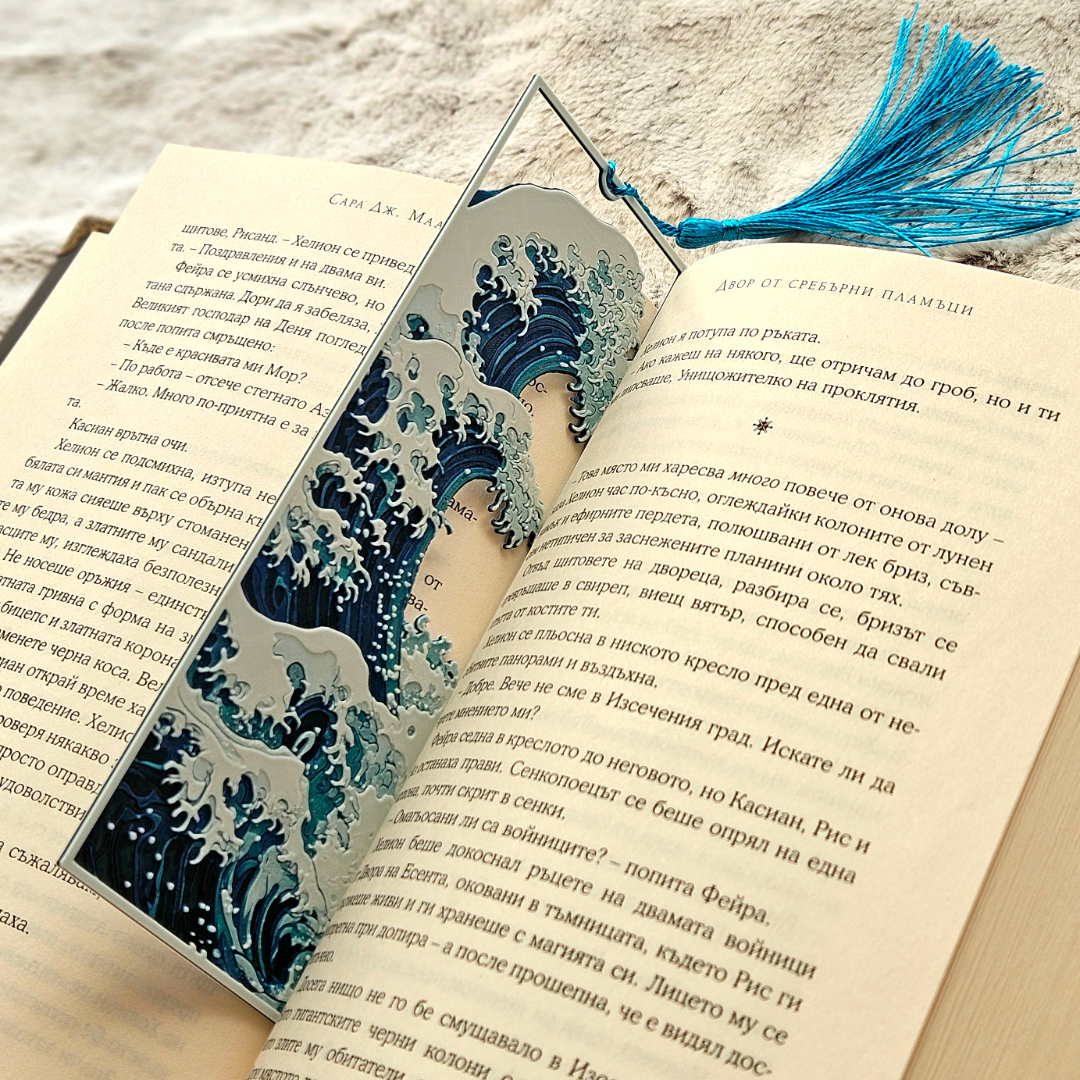 Open book with a decorative bookmark featuring wave design on a textured surface
