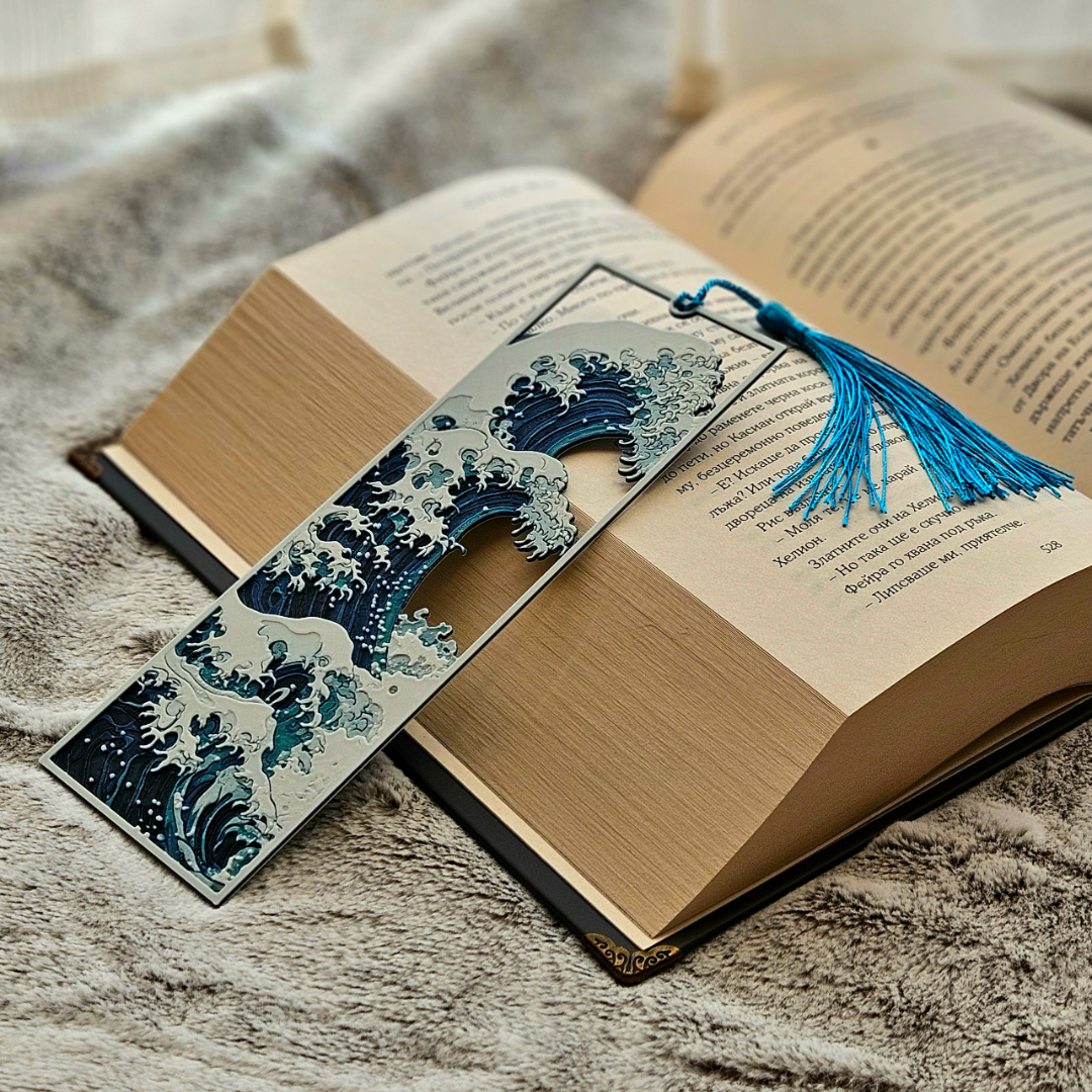 Decorative wave-shaped bookmark with tassel on an open book