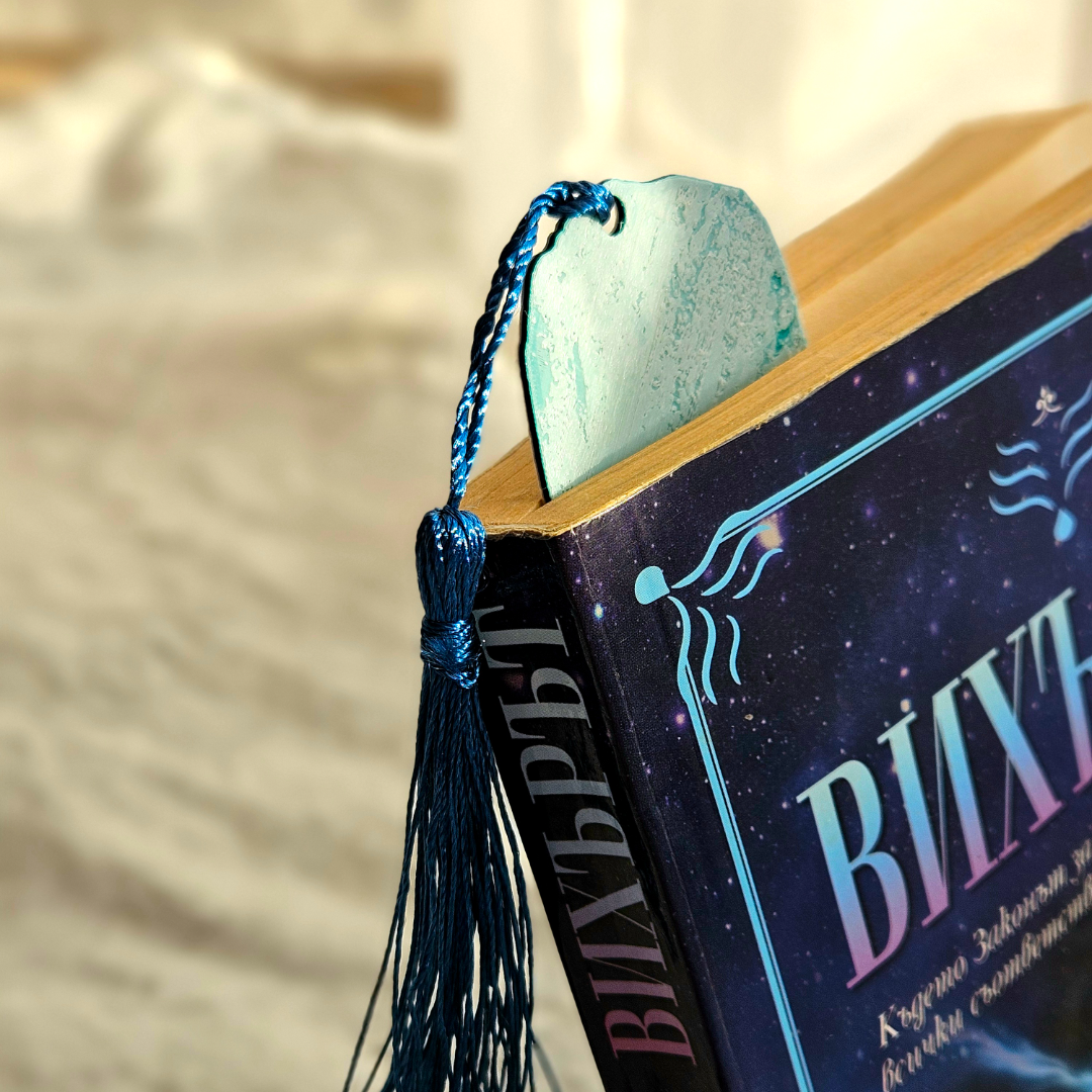 Book with a decorative bookmark featuring a tassel on a blurred background
