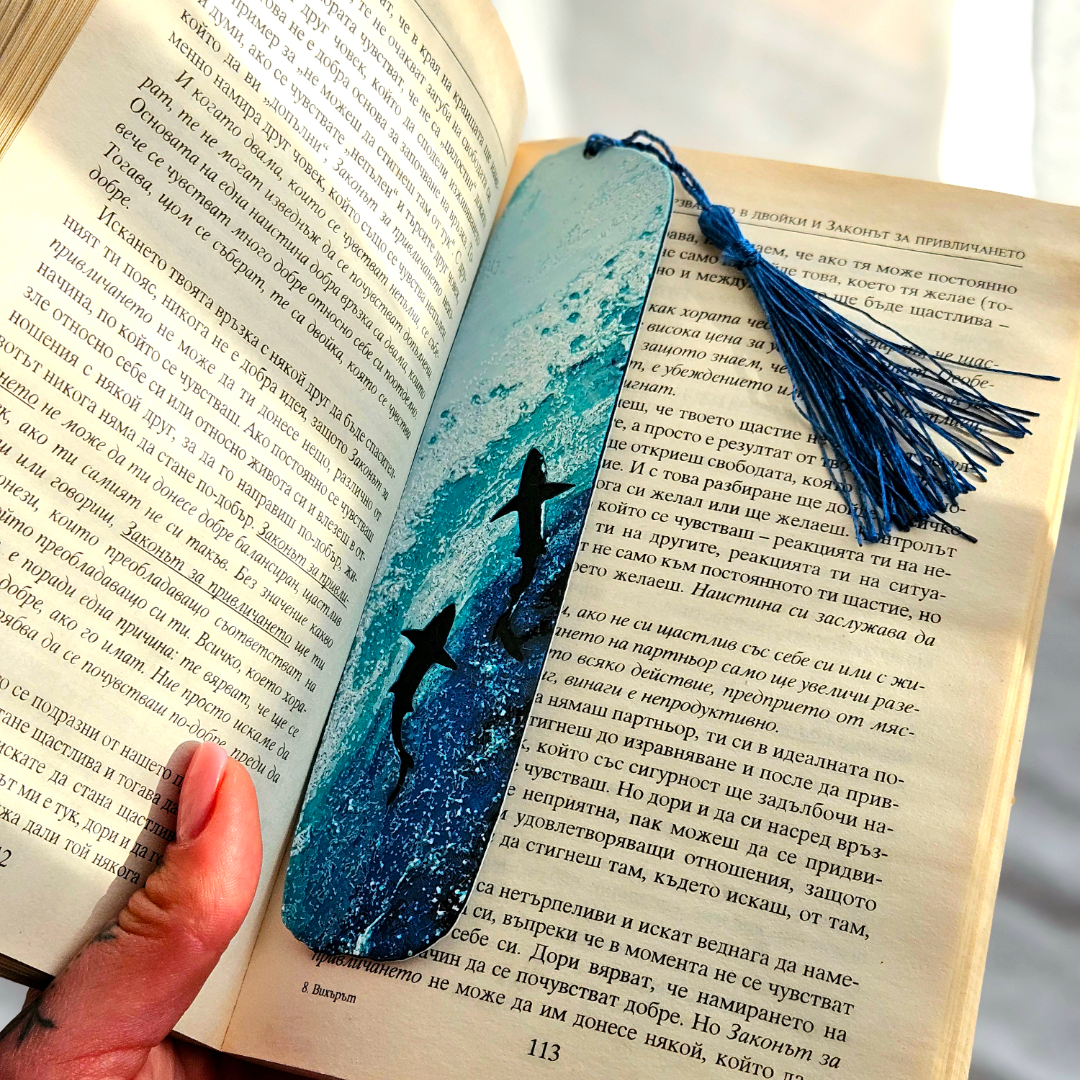 Blue bookmark with tassel on an open book