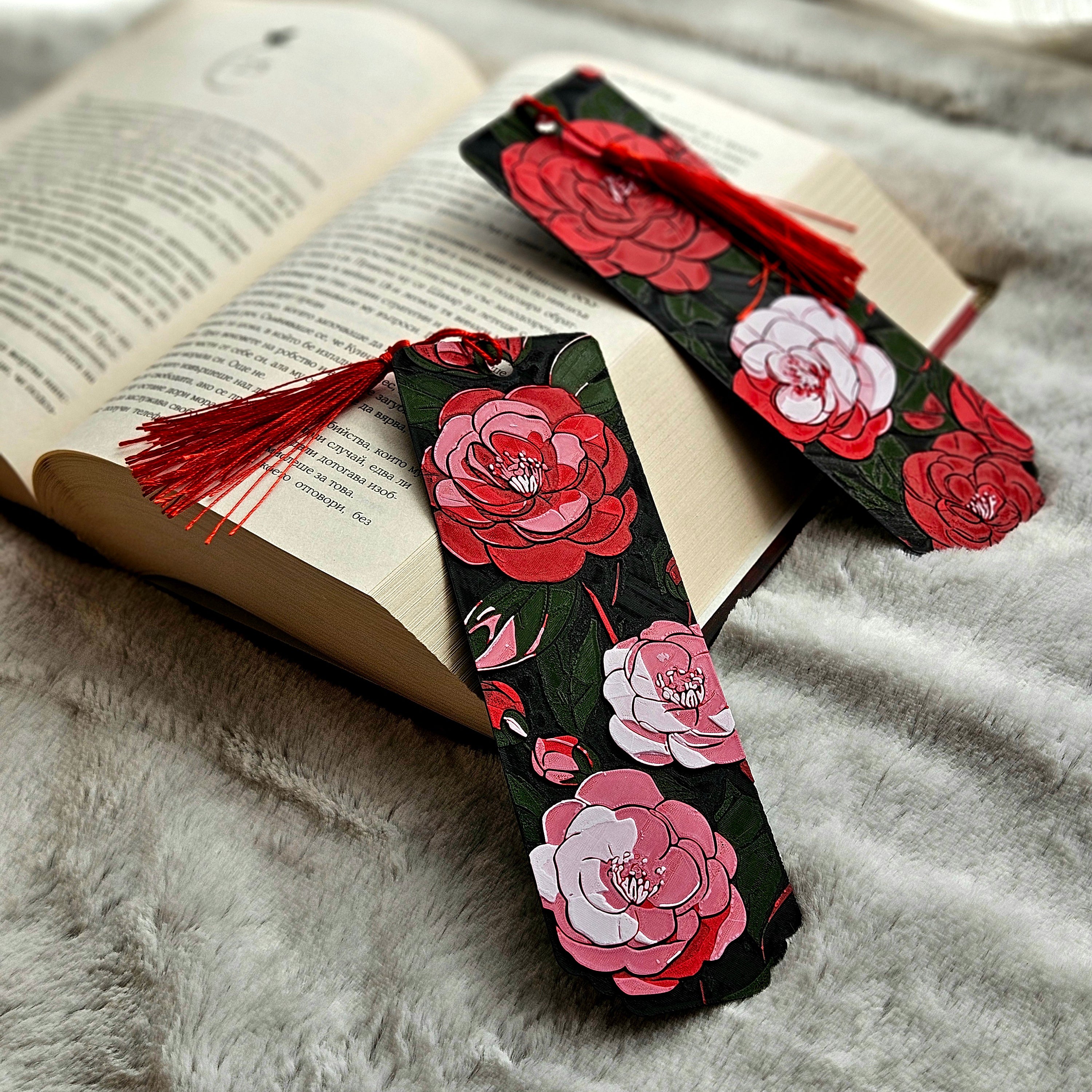 Floral bookmarks with red and pink flowers on a gray fabric background
