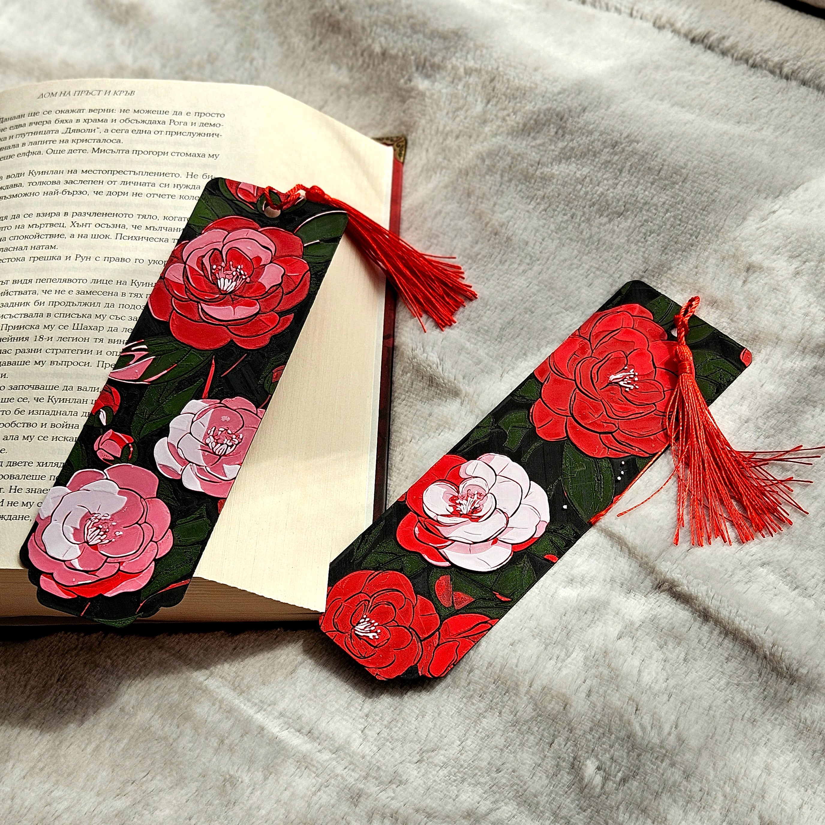 Floral bookmarks with tassels on an open book