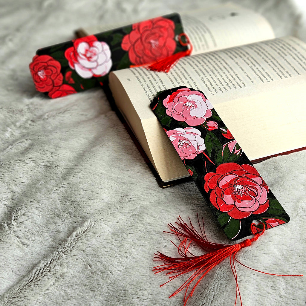 Floral bookmark with red tassel on an open book