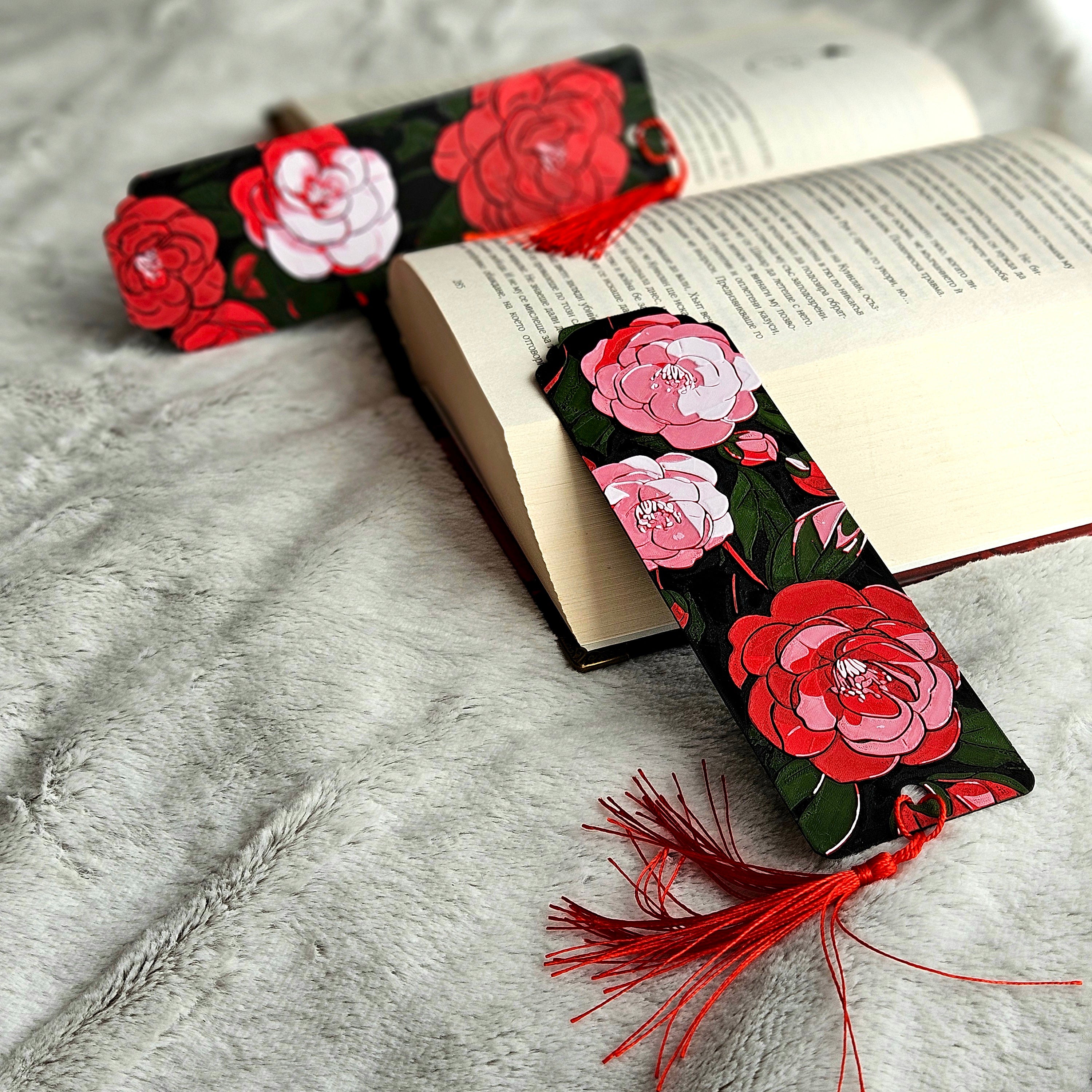 Floral bookmark with red tassel on an open book