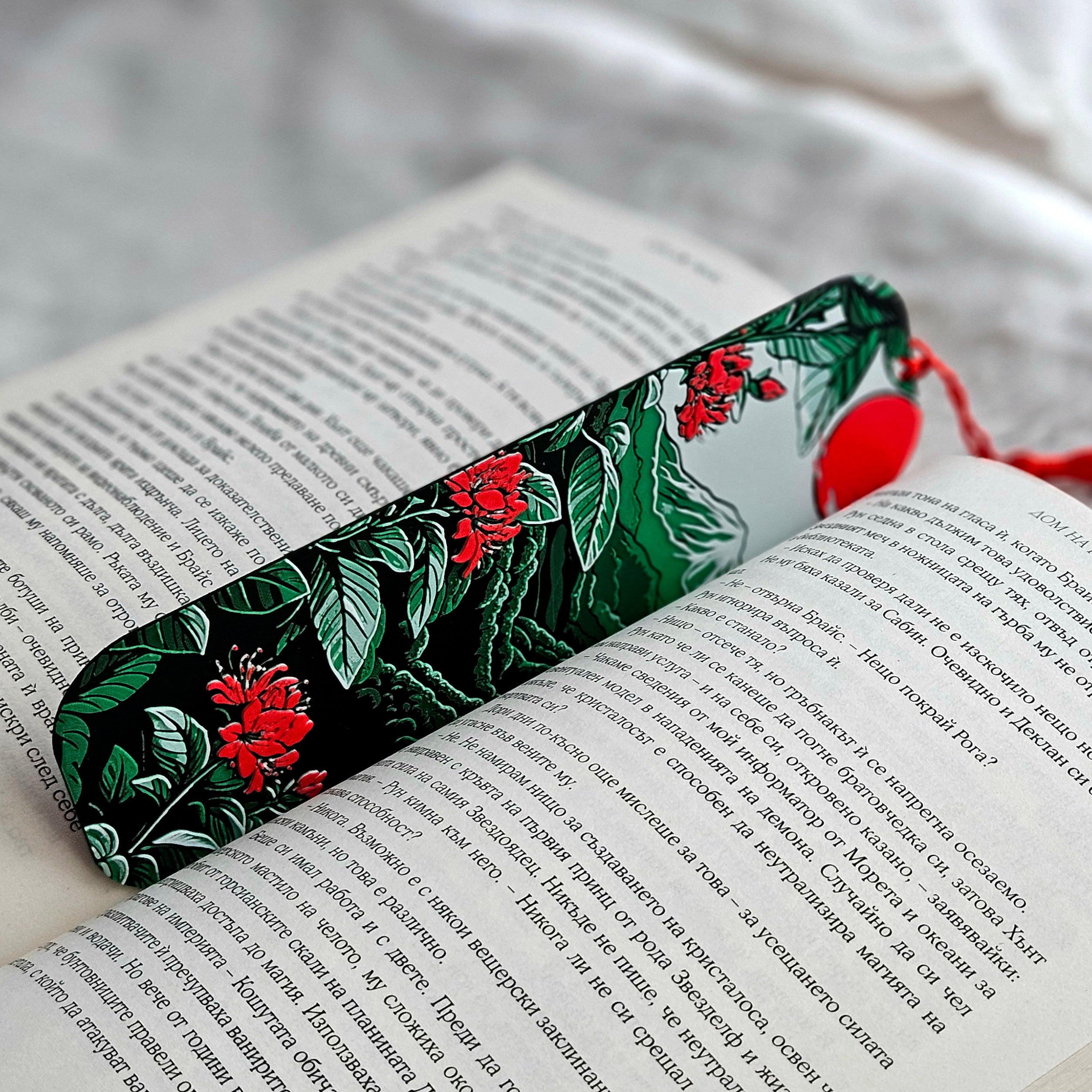 Floral bookmark on an open book with a red tag