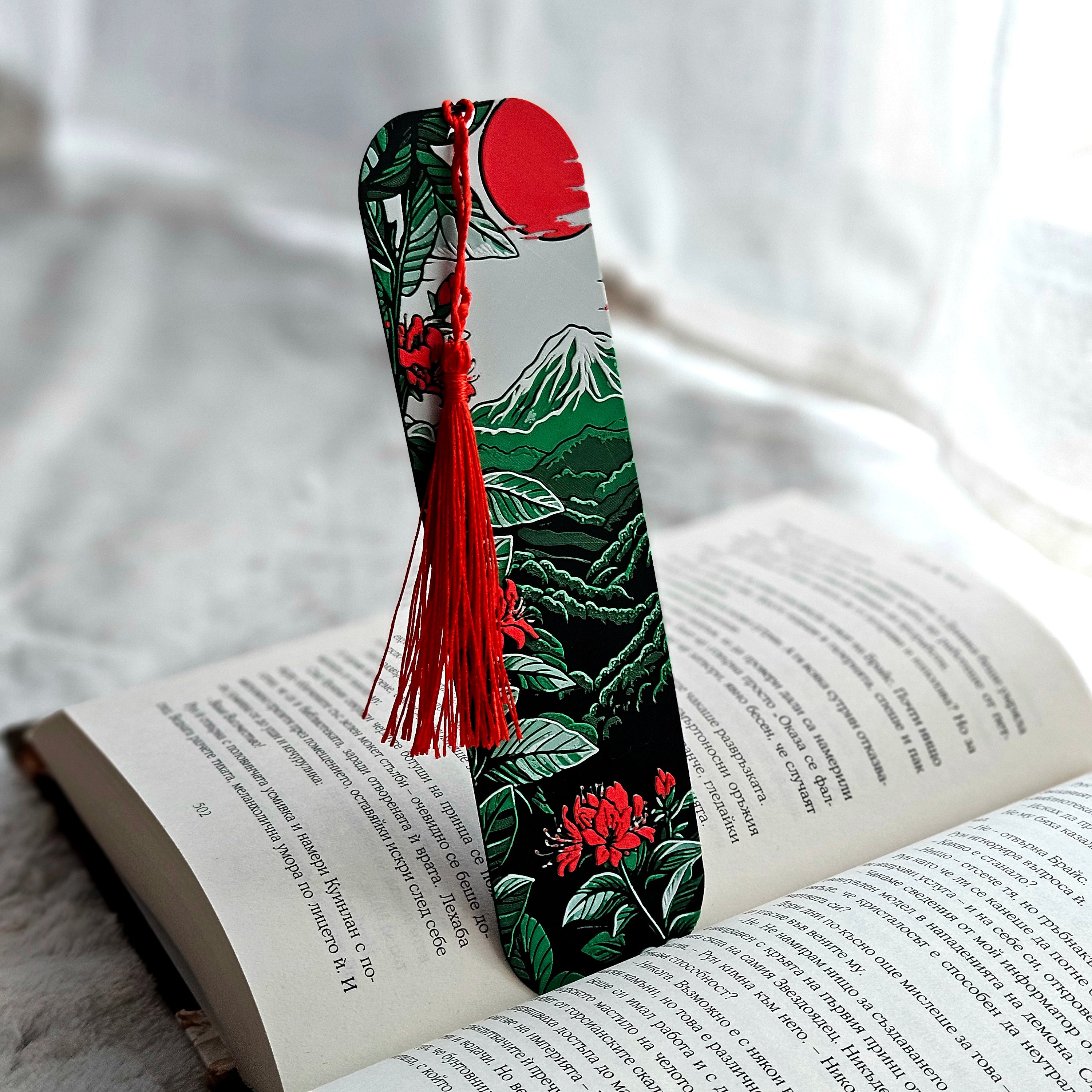 Decorative bookmark with tassel on an open book against a soft white background