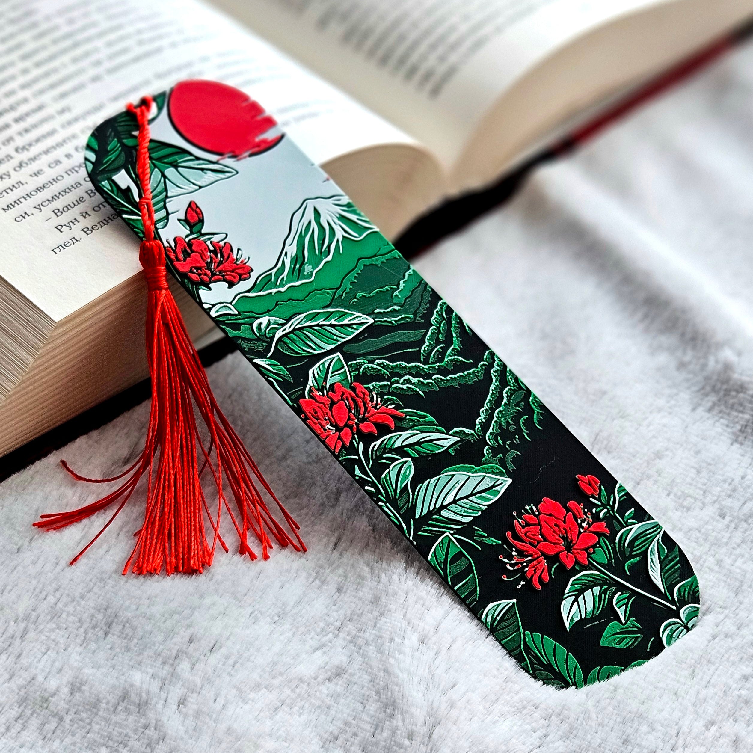 Decorative bookmark with floral design and red tassel on an open book
