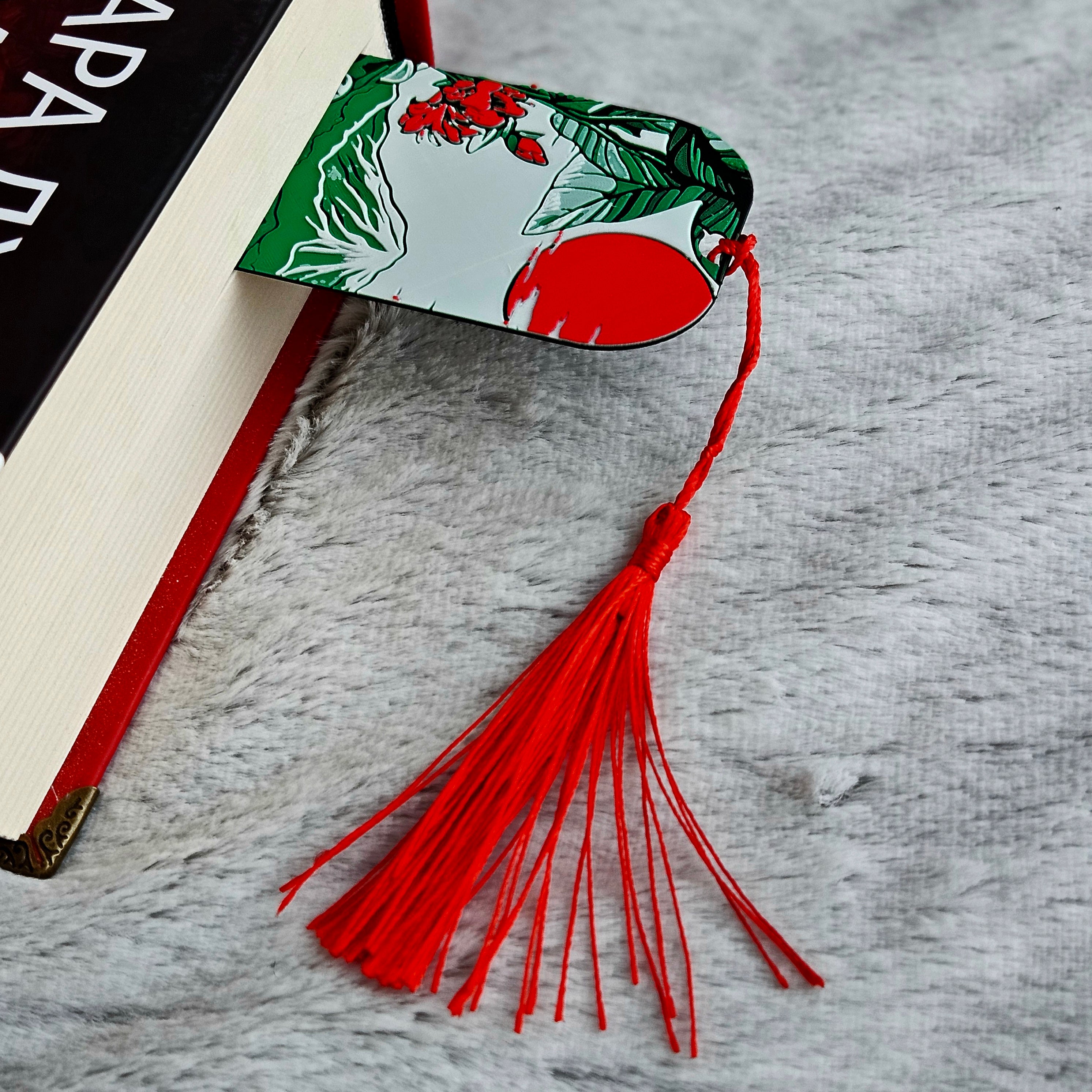 Decorative bookmark with tassel on a textured surface