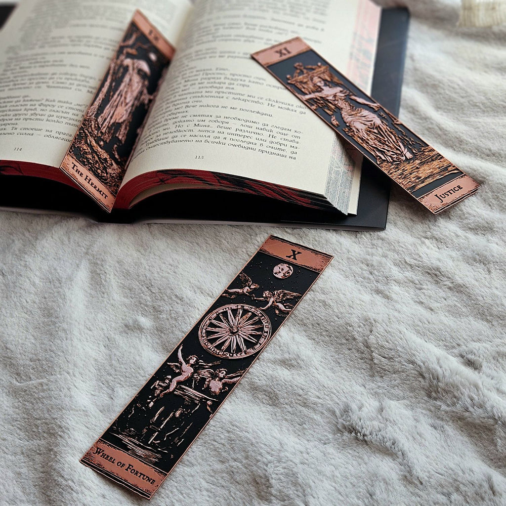 Decorative bookmarks with tarot card designs on an open book