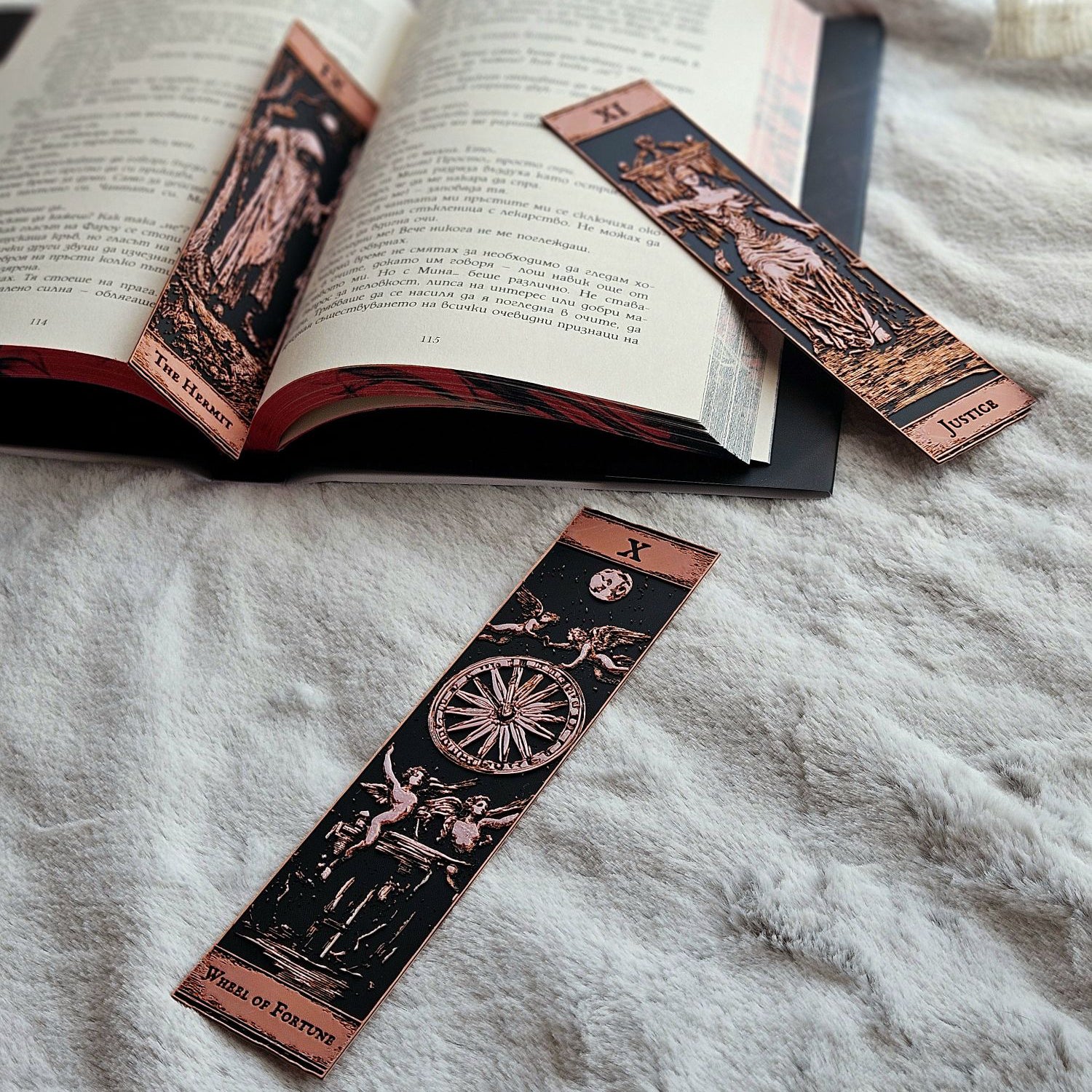 Decorative bookmarks with tarot card designs on an open book