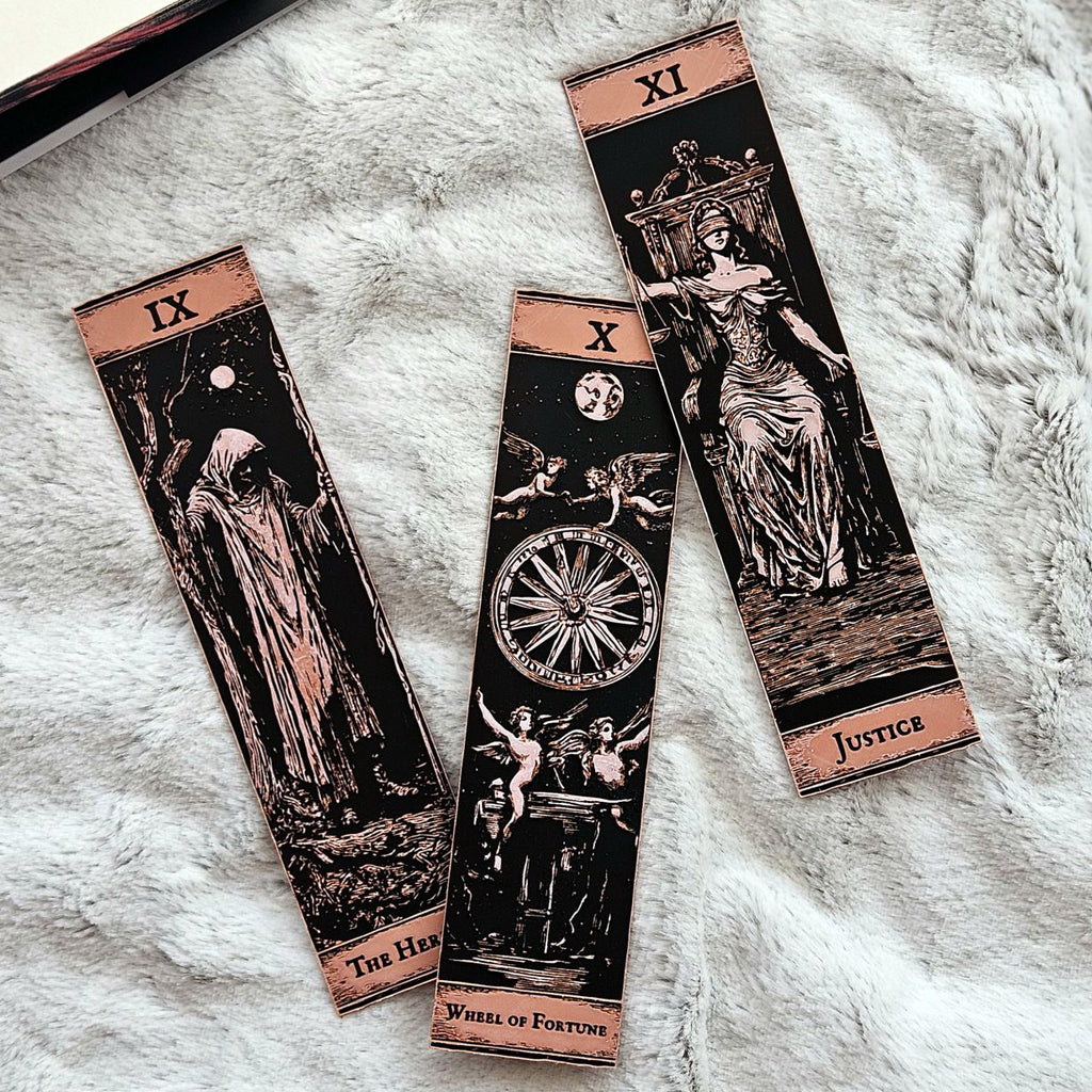 Three tarot card bookmarks on a textured white surface