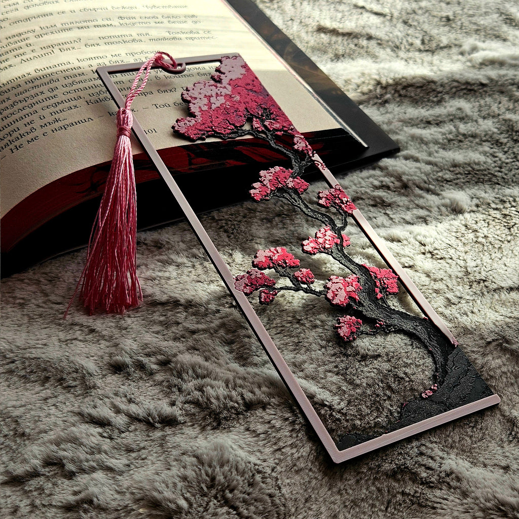 Decorative cherry blossom bookmark with tassel on an open book