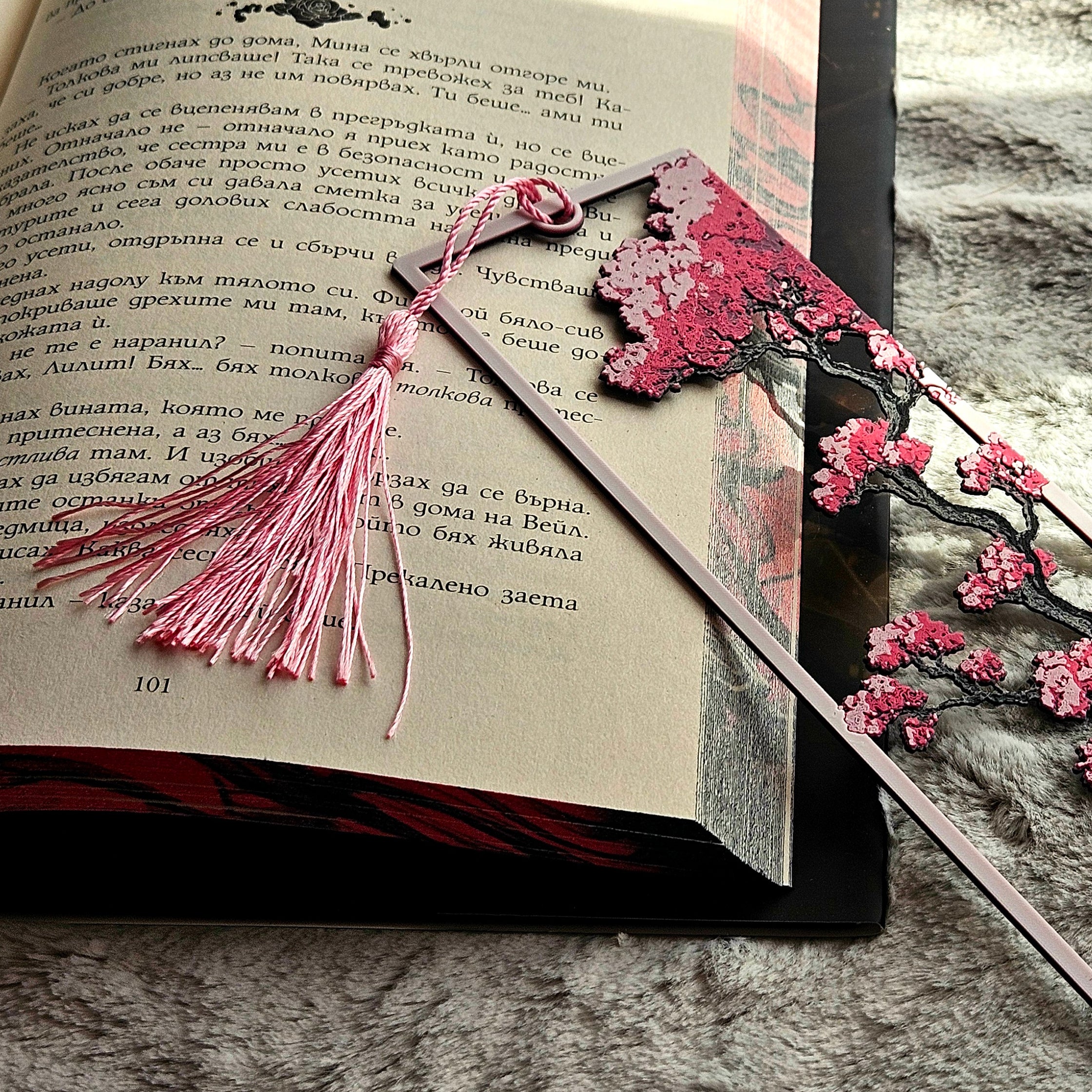 Decorative bookmark with cherry blossoms on an open book