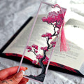 Bookmark with cherry blossom design held over an open book