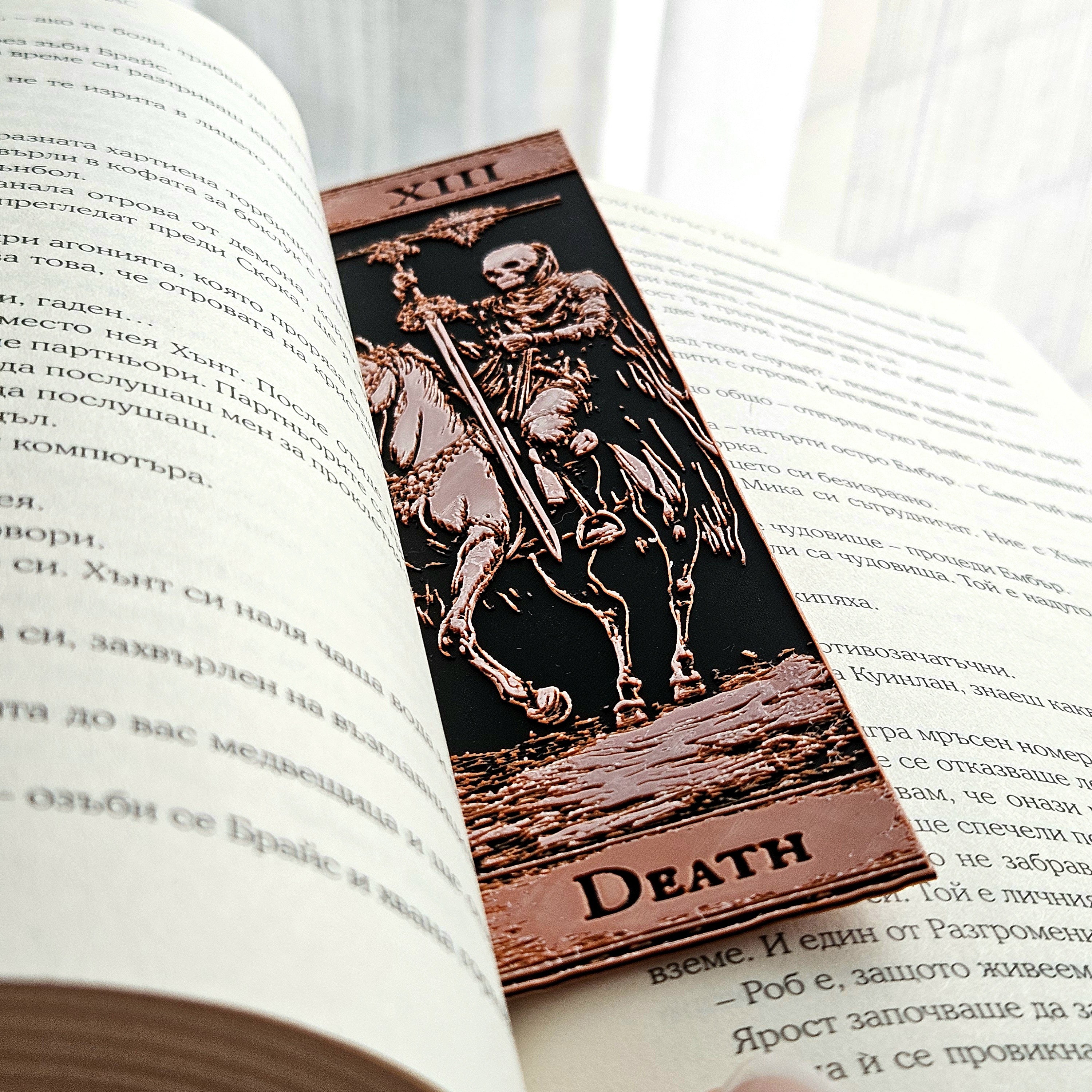 Bookmark with tarot card design titled 'Death' on an open book