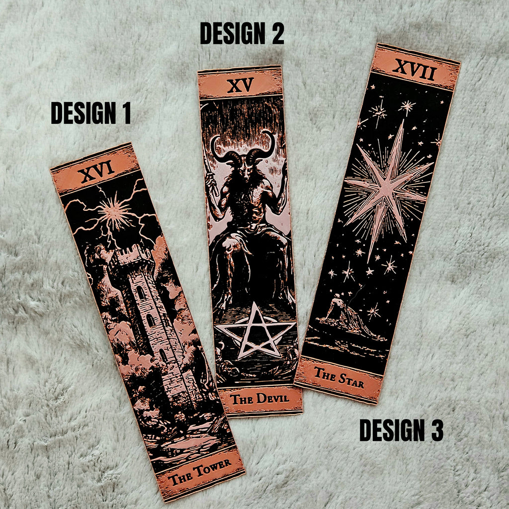 Three tarot card designs on a textured gray background
