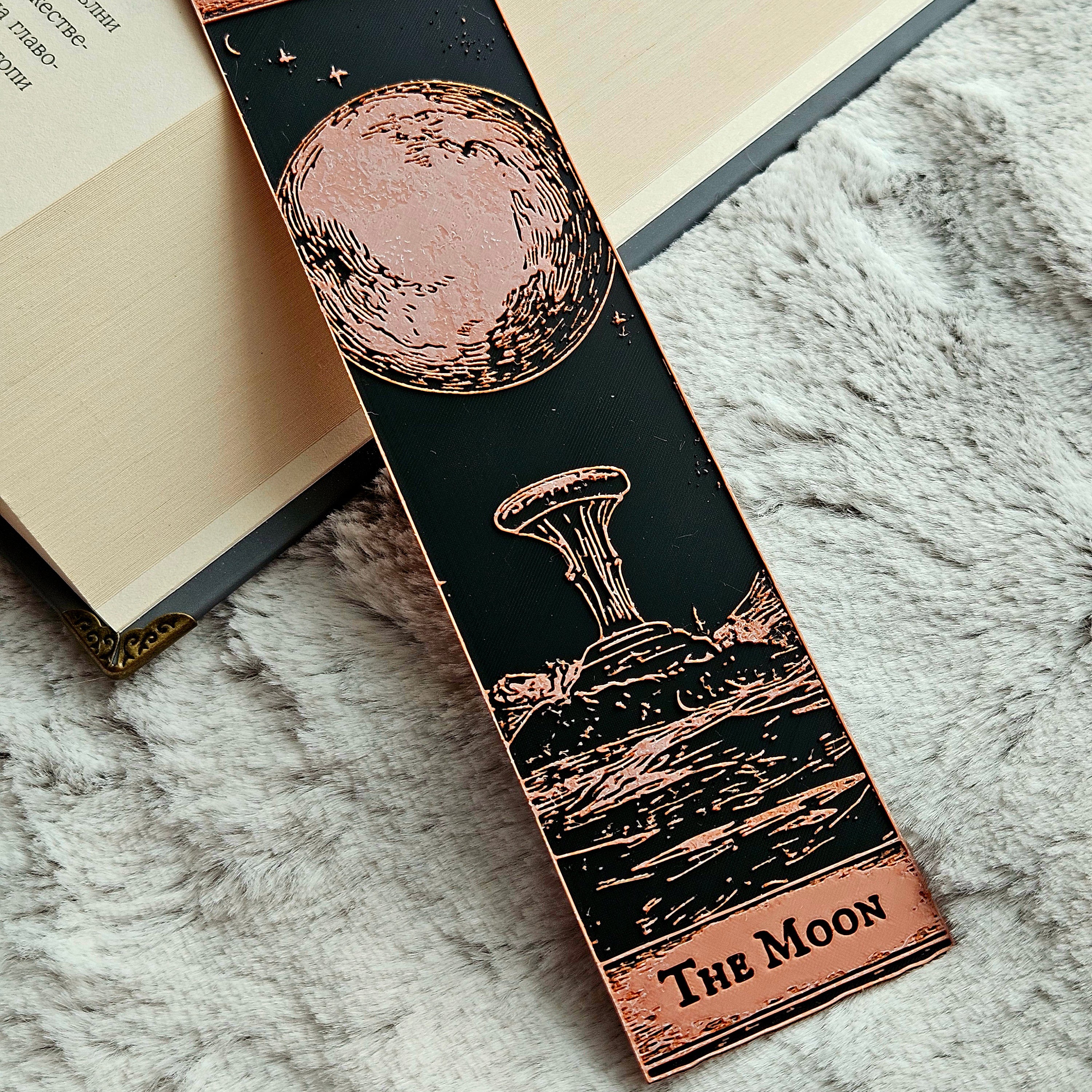Bookmark with celestial design and 'The Moon' text on a textured surface