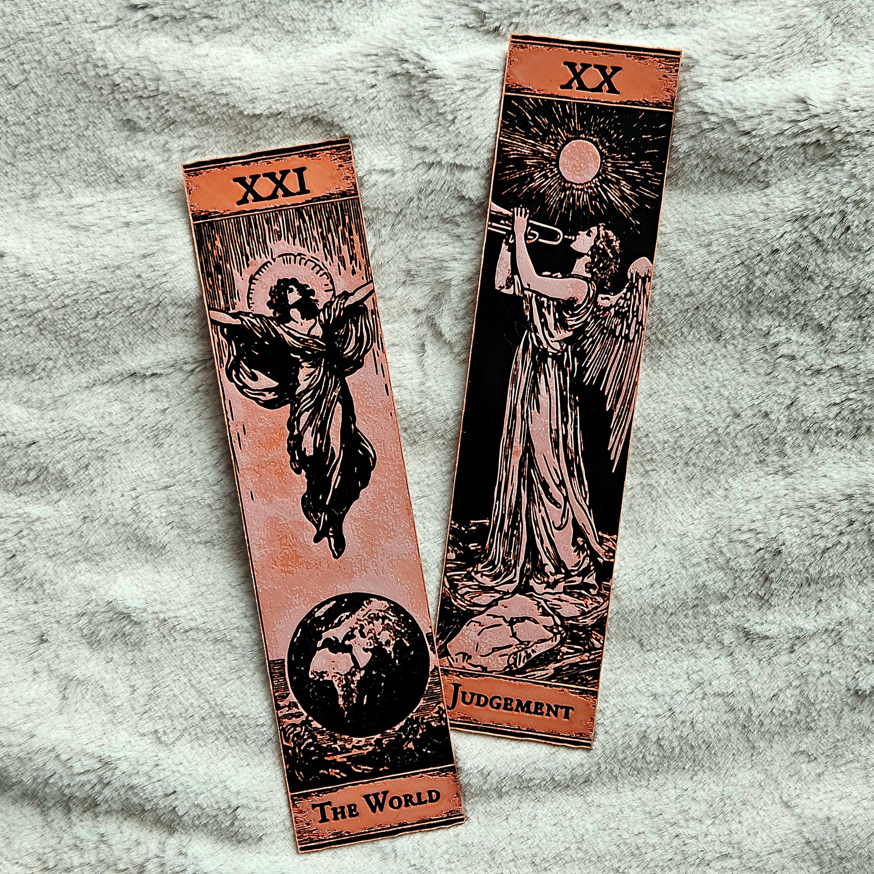 Two tarot cards titled 'Judgment' and 'The World' on a textured surface.