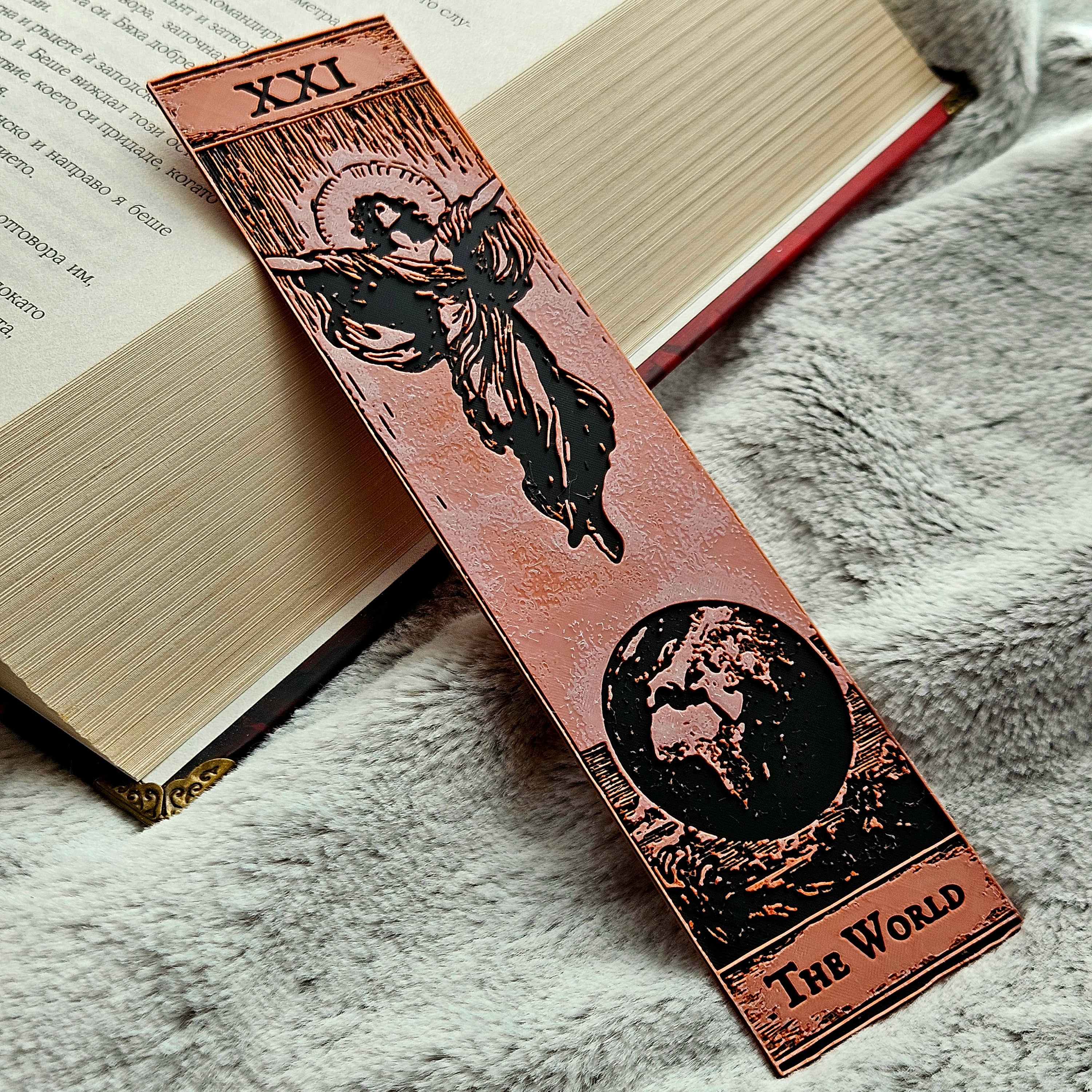 Decorative bookmark with tarot card design on a book