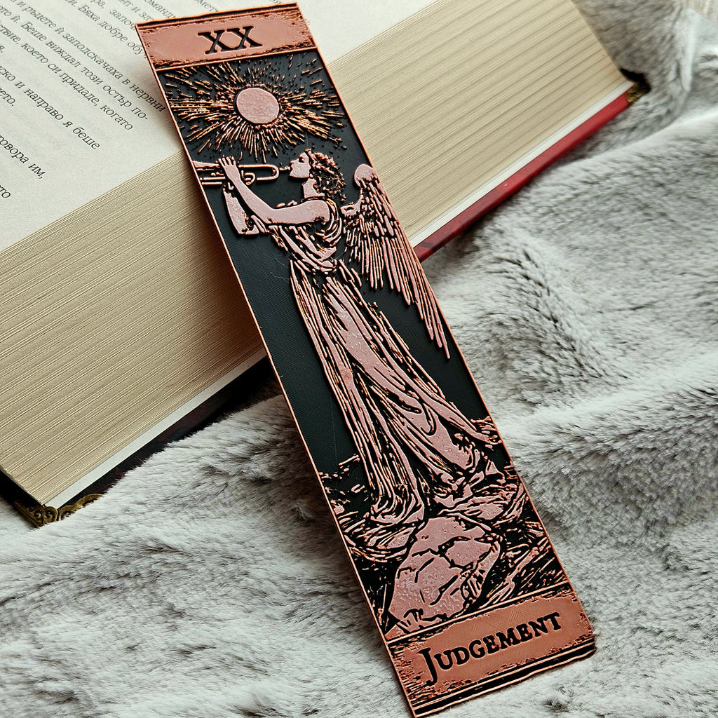 Decorative bookmark with angel design and 'Judgment' text on an open book.