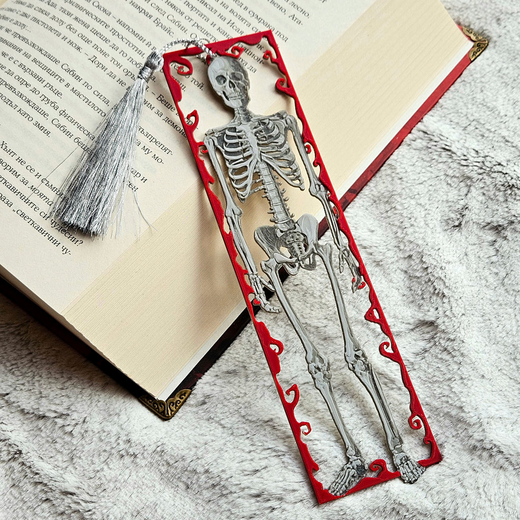 Skeleton design bookmark on an open book with a tassel.
