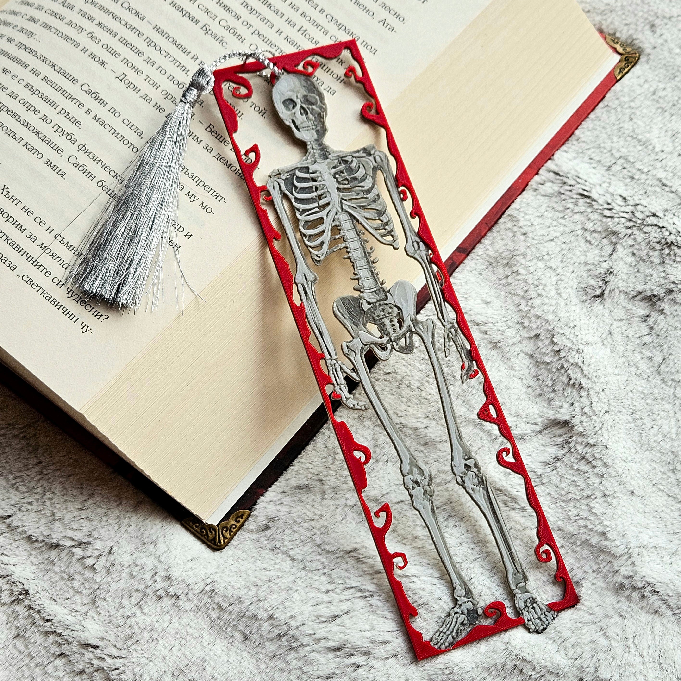 Skeleton design bookmark on an open book with a tassel.