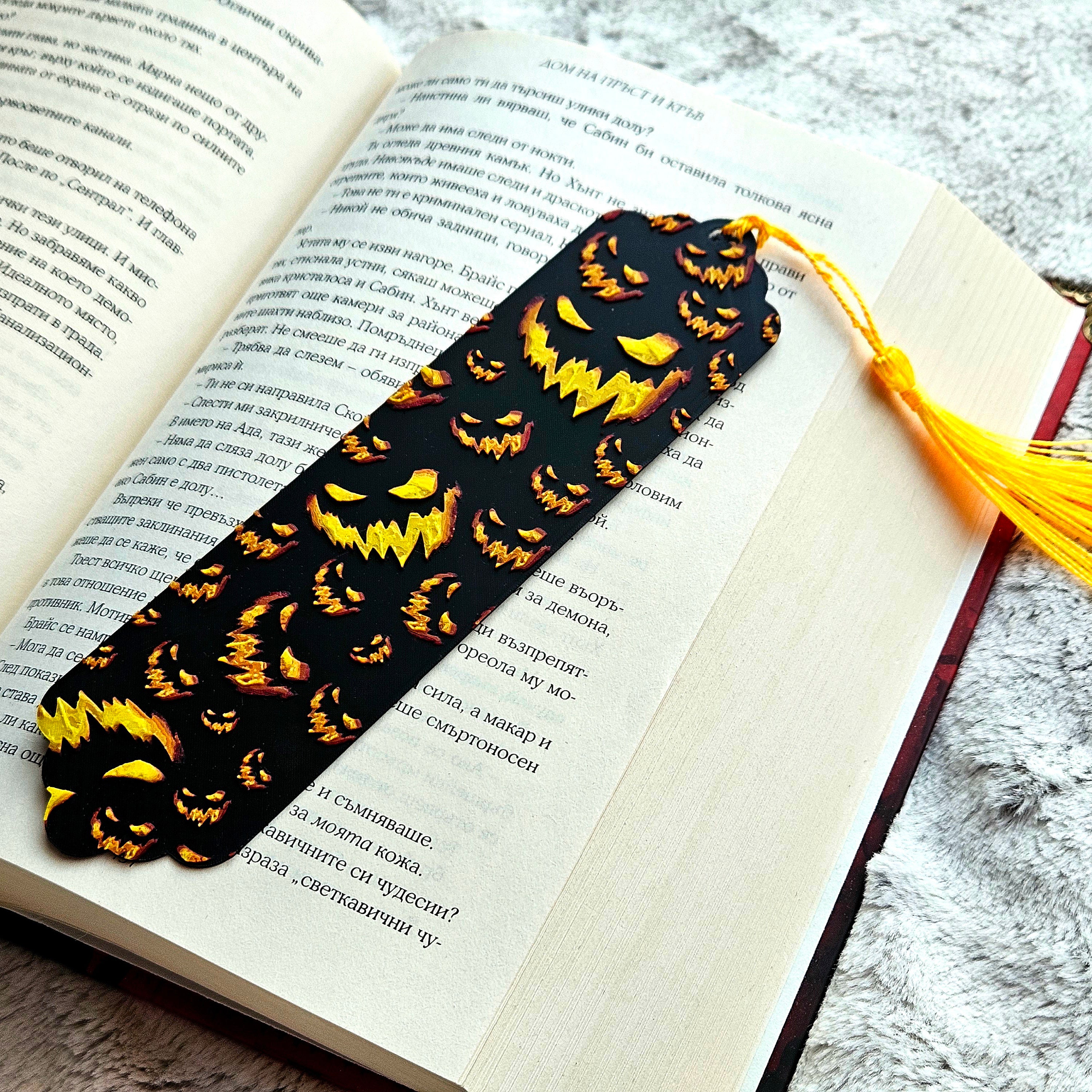 Bookmark with jack-o'-lantern design on an open book